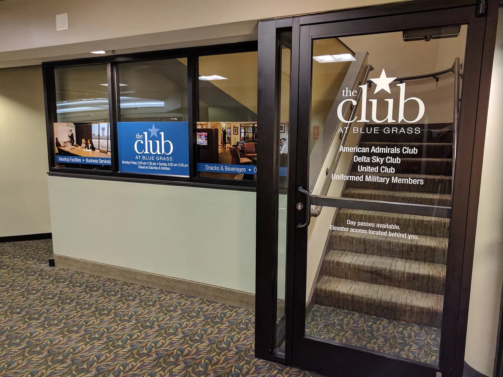 Glass door and window for The Club at Blue Grass on an upper-level stair, photographed in September 2017.