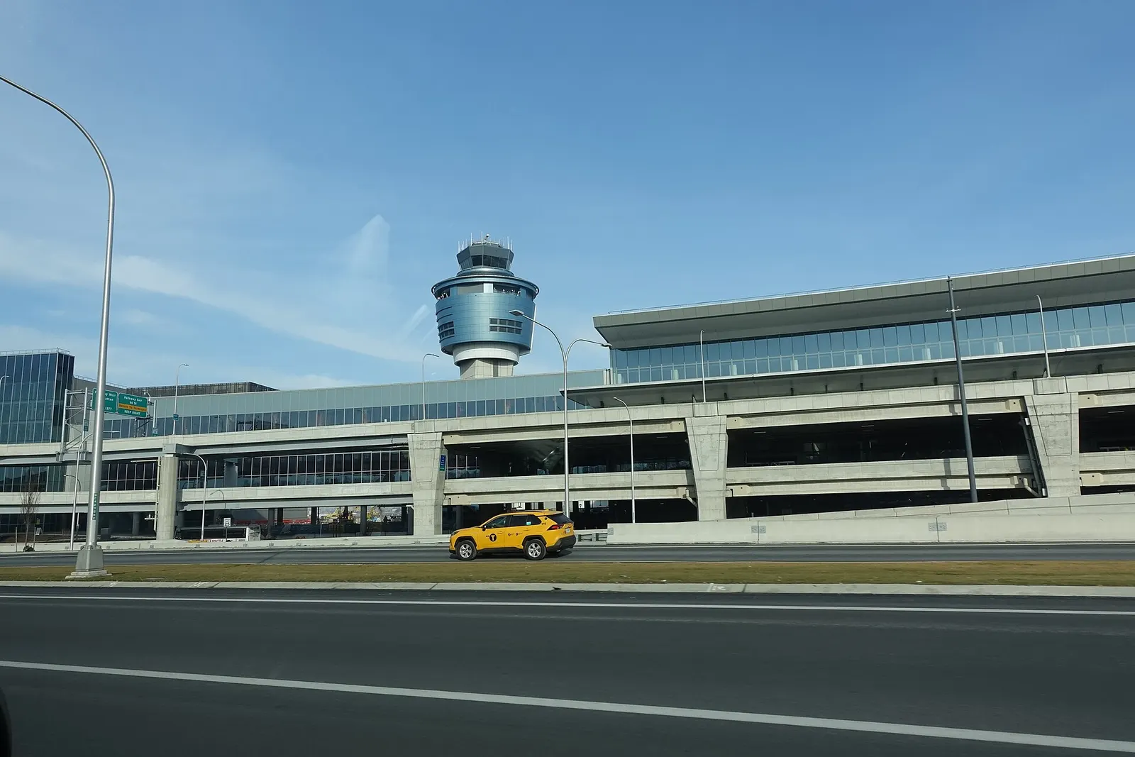 Traveling west on the Grand Central Parkway through LaGuardia Airport in East Elmhurst, Queens. Pictured is the air traffic control tower next to Terminal B (Central Terminal).
