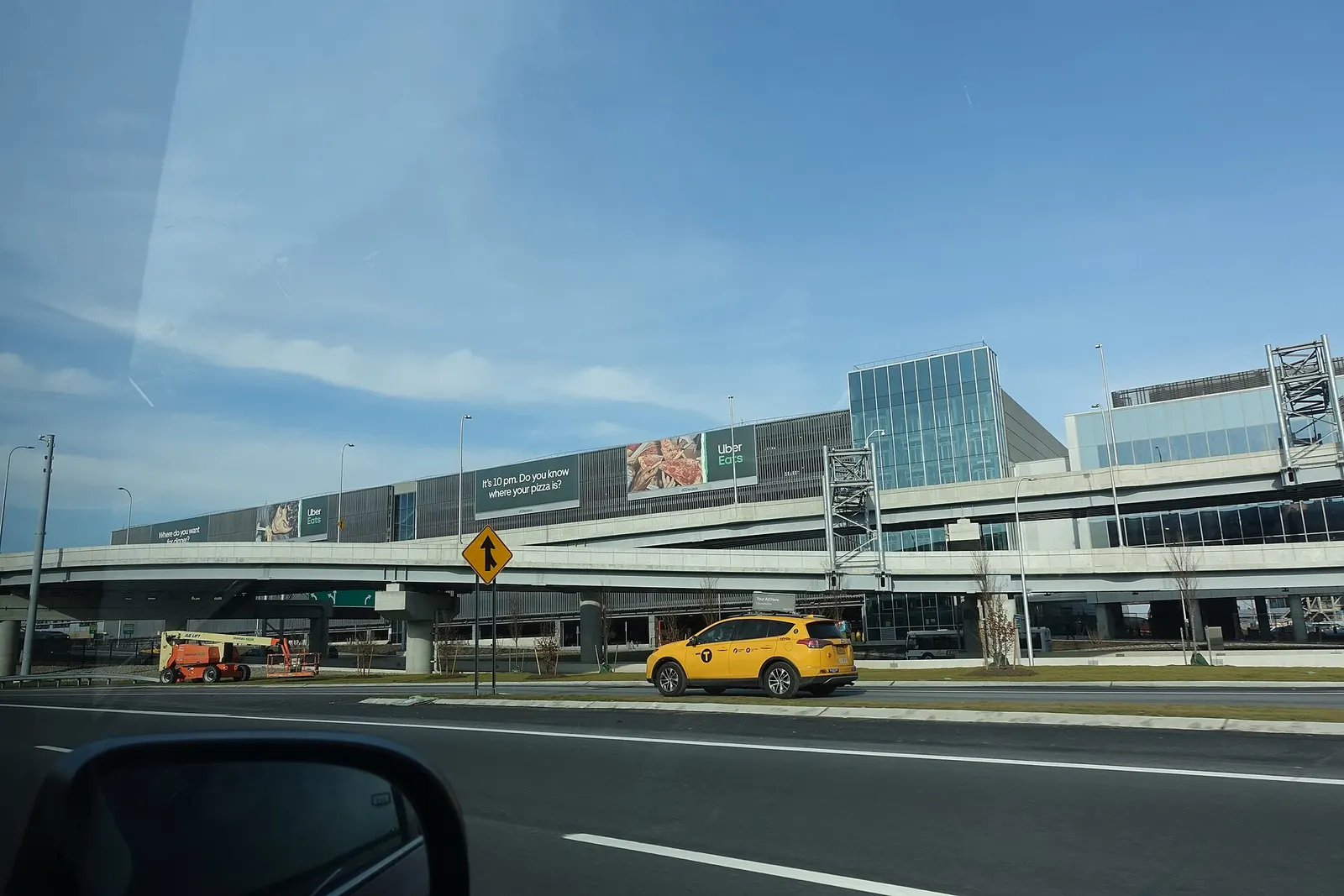 Traveling west on the Grand Central Parkway through LaGuardia Airport in East Elmhurst, Queens. Pictured is the parking garage next to Terminal B (Central Terminal).