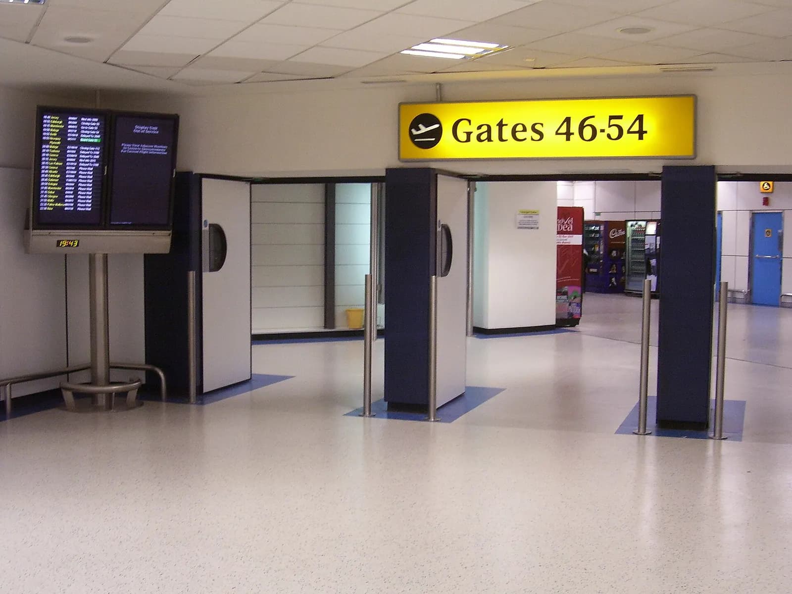 The North Terminal gate area at London Gatwick with departure information screens, seating, and boarding gates.