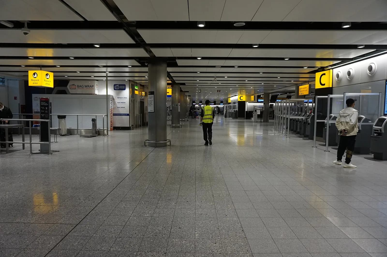 The Terminal 3 check-in area with airline counters, queue barriers, overhead signage, and passengers waiting with luggage.