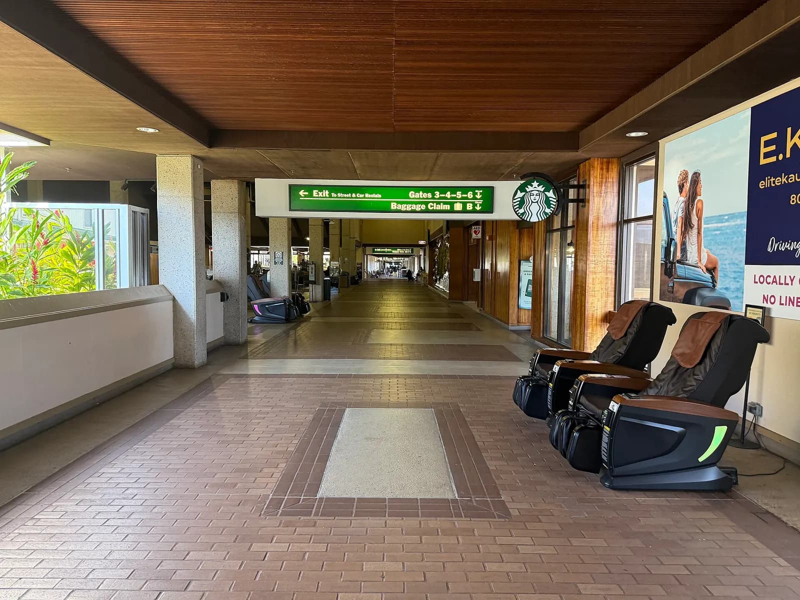 Airside corridor at Lihue Airport with Starbucks and a sign for Gates 3–6, Baggage Claim B, and car rentals