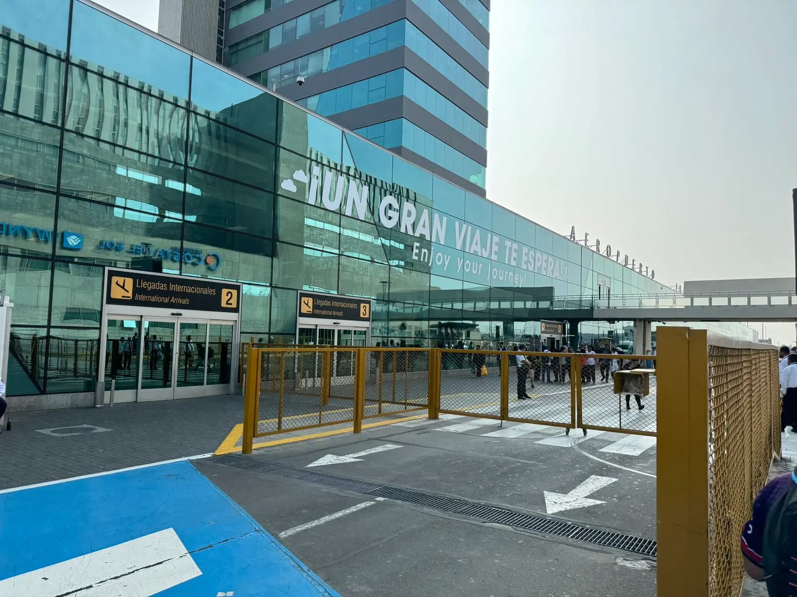 The main terminal facade of Jorge Chávez International Airport with its entrance canopy, signage, and passenger drop-off area in front.