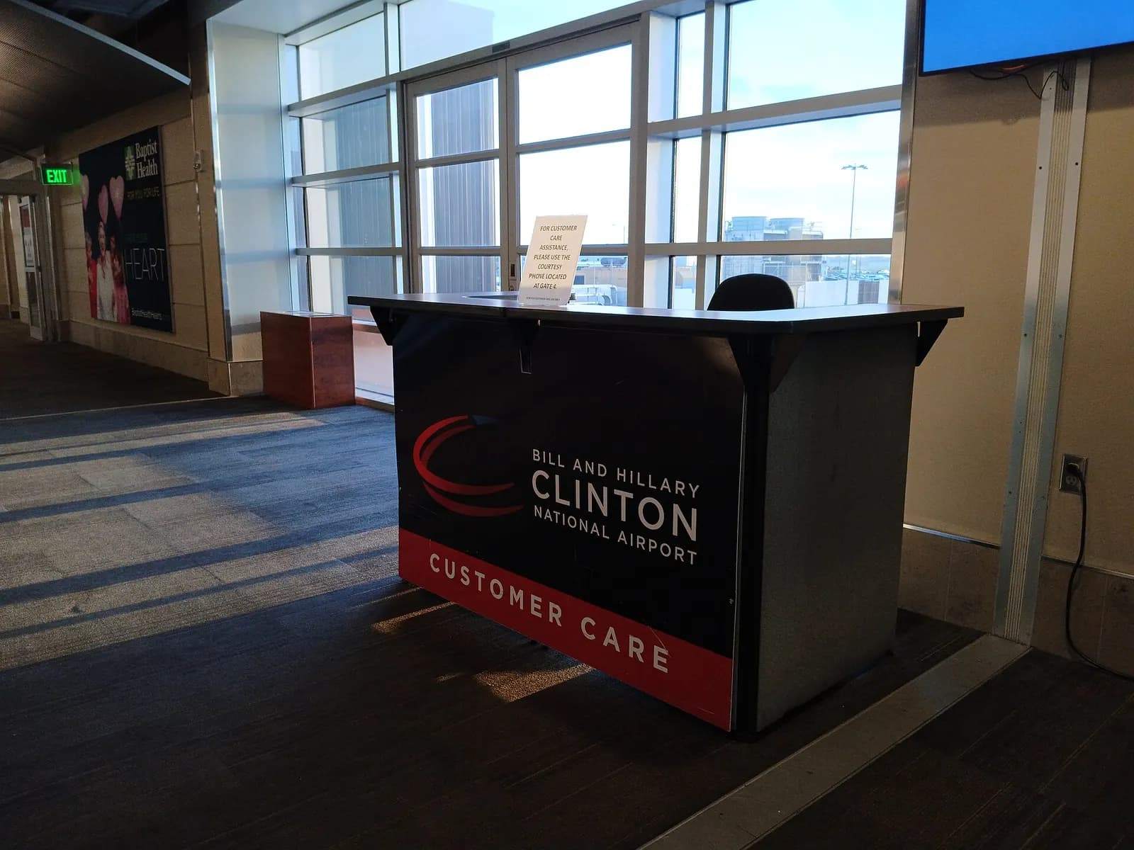 Customer Care desk on the upper level of Clinton National Airport, across from Riverbend, photographed 4 July 2024.