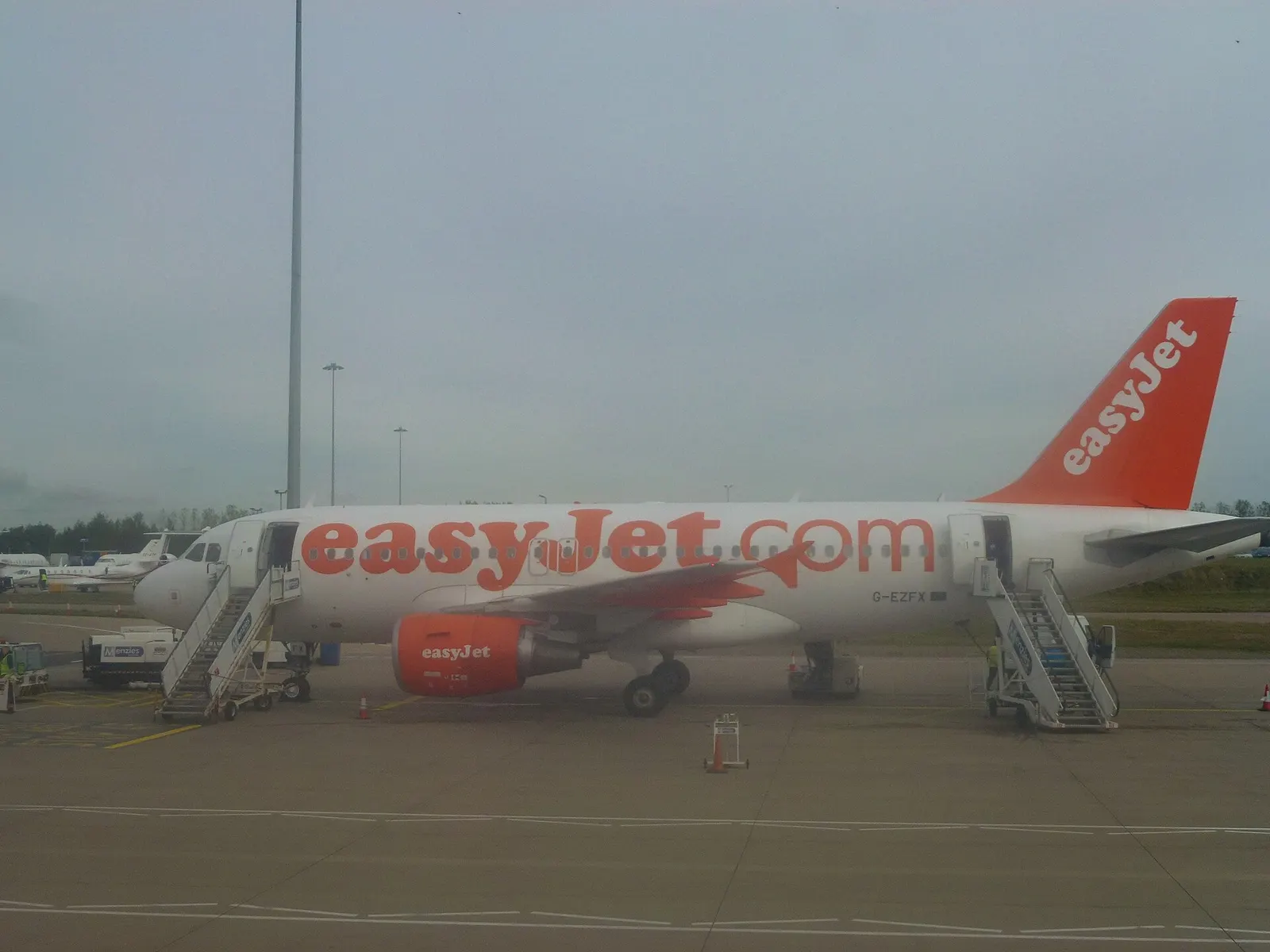 easyJet Airbus on stand at London Luton Airport with terminal buildings behind