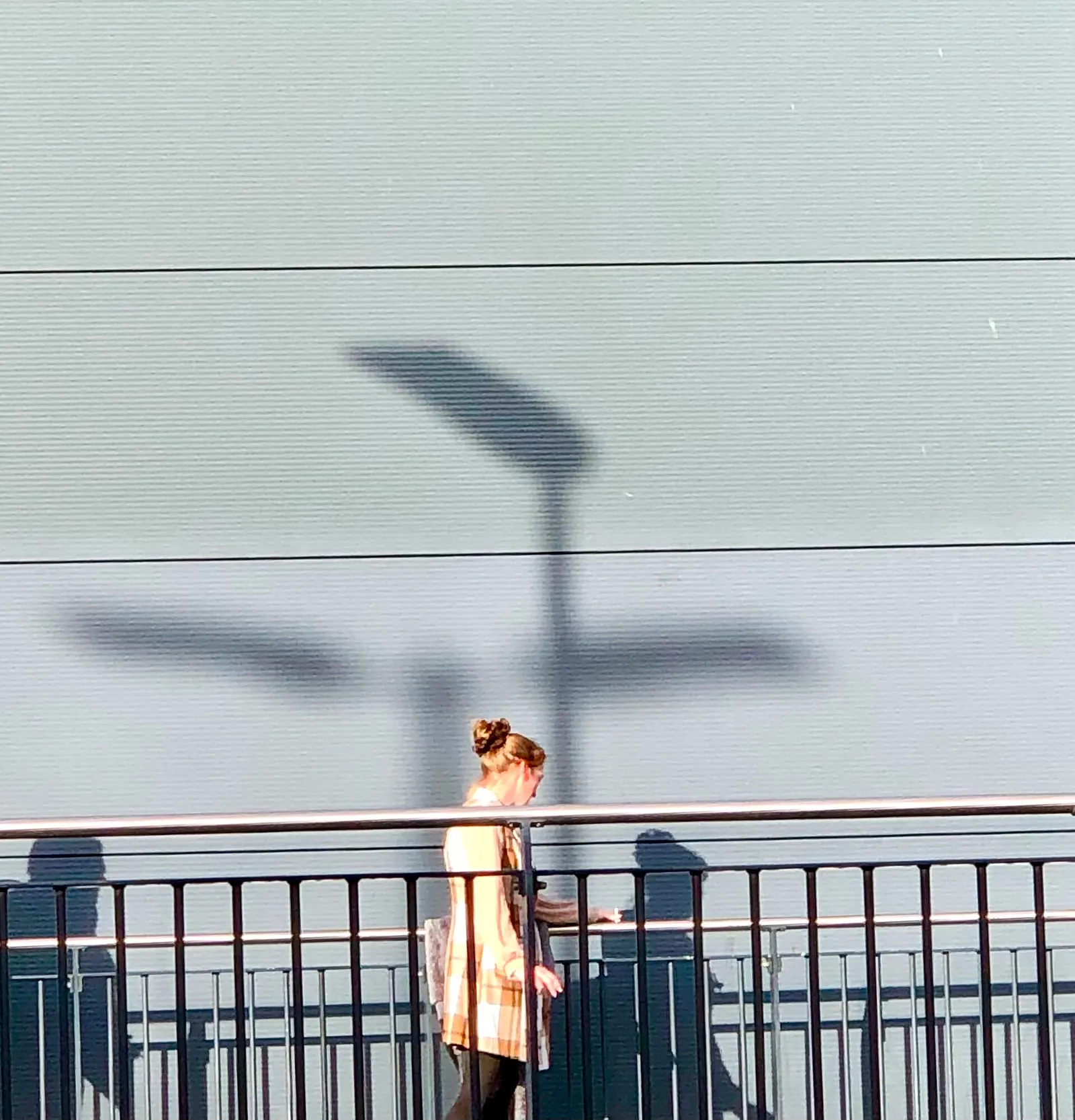 Traveler walking past London Luton Airport terminal glazing in November 2024