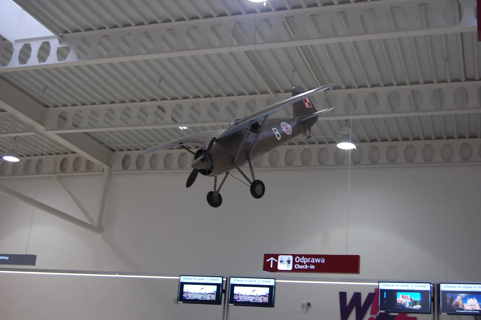 Historic aircraft model hanging above Lublin Airport check-in