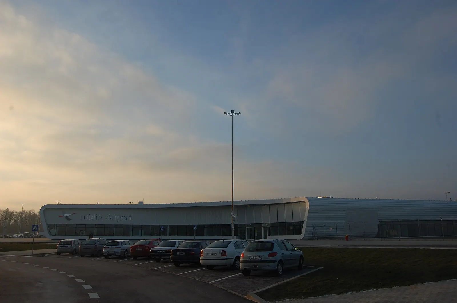 Lublin Airport terminal and parking bays at dusk