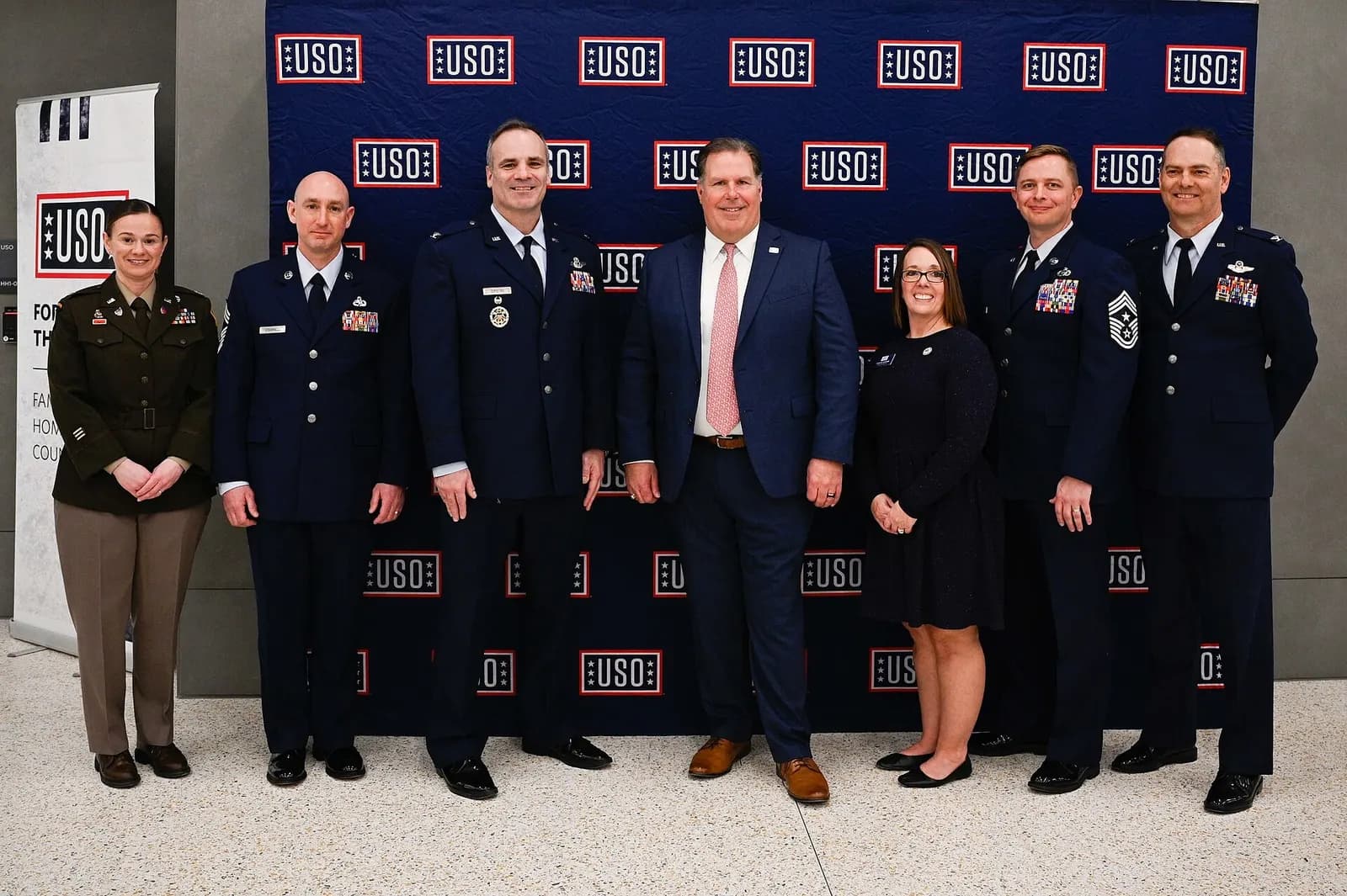 Whiteman Air Force Base leadership and the United Service Organizations Inc. leadership and members stand for a photo after the ribbon-cutting ceremony at the new terminal in the Kansas City International Airport in Kansas City, Missouri, Feb. 27, 2023. The USO’s new airport center provides a place 