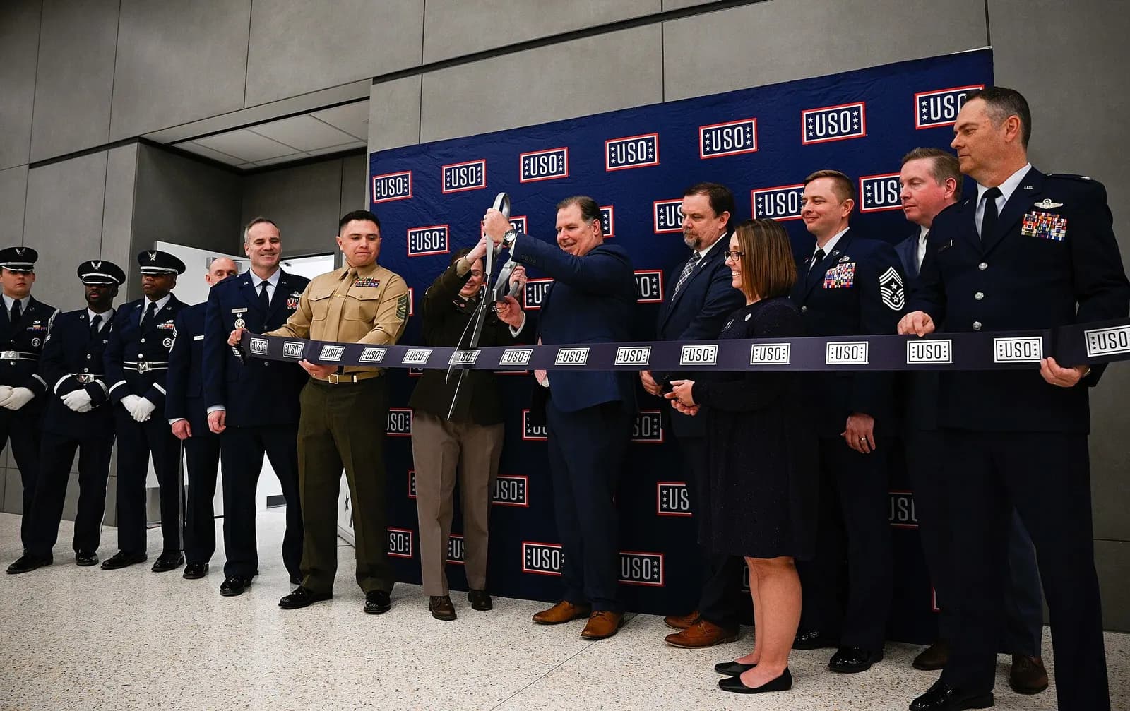 Whiteman Air Force Base leadership and Honor Guard Airmen participate in the United Service Organizations Inc. ribbon-cutting ceremony at the new terminal in the Kansas City International Airport in Kansas City, Missouri, Feb. 27, 2023. The USO helps to strengthen America's military service by keepi