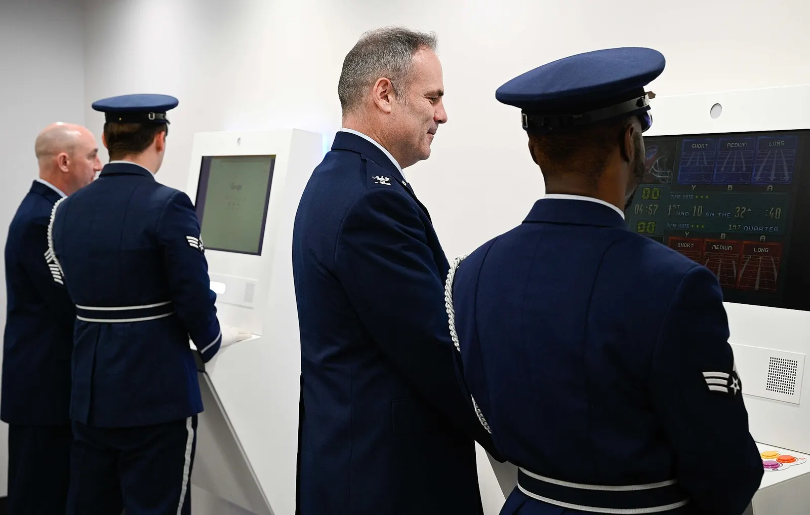 Whiteman Air Force Base leadership and Honor Guard Airmen play video games after the ribbon-cutting ceremony at the new terminal in the Kansas City International Airport in Kansas City, Missouri, Feb. 27, 2023. The USO’s new airport center provides games, movies, snacks and a place to rest at the ai