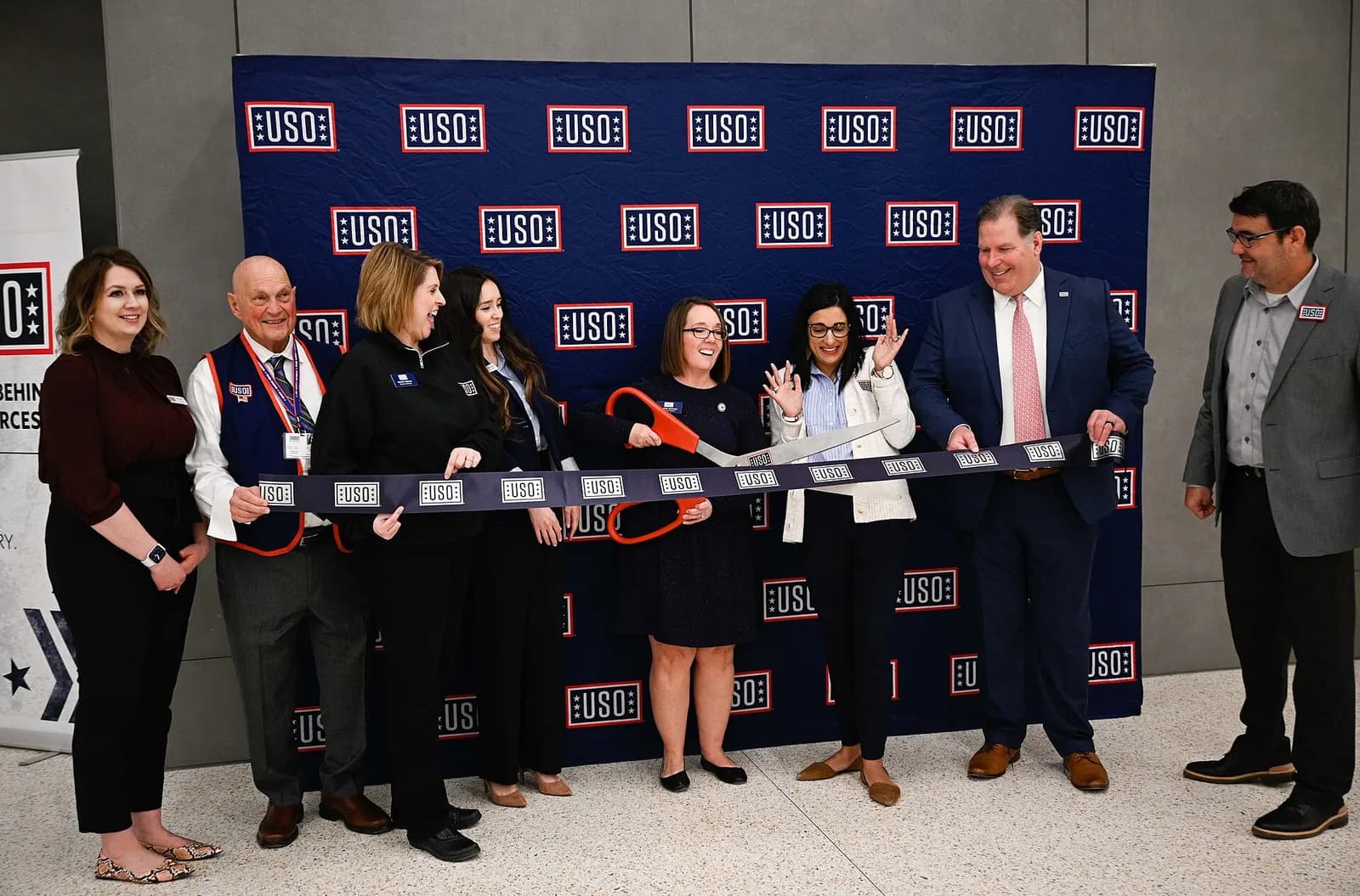 The United Service Organizations Inc. leadership, members and volunteers cut the ribbon at the USO ribbon-cutting ceremony at the new terminal in the Kansas City International Airport in Kansas City, Missouri, Feb. 27, 2023. The USO operates centers at or near military installations across the Unite