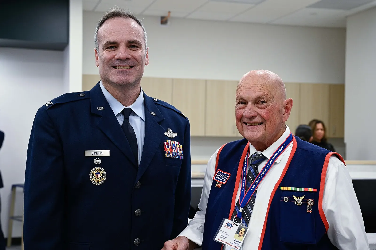 U.S. Air Force Col. Maxwell Dipietro, 509th Bomb Wing vice commander, and Thomas Stiefvater, United Service Organizations Inc.volunteer, stand for photo after the ribbon-cutting ceremony at the new terminal in the Kansas City International Airport in Kansas City, Missouri, Feb. 27, 2023. The reach o