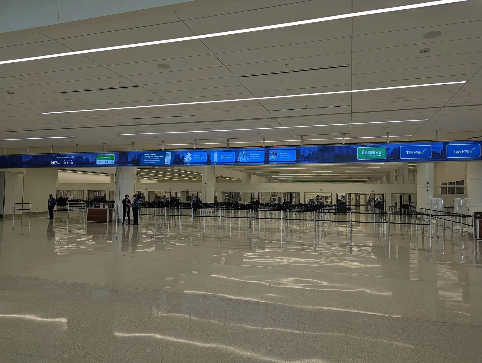 The TSA security checkpoint in Terminal C at Orlando International Airport with multiple screening lanes, conveyor belts, and overhead signage.