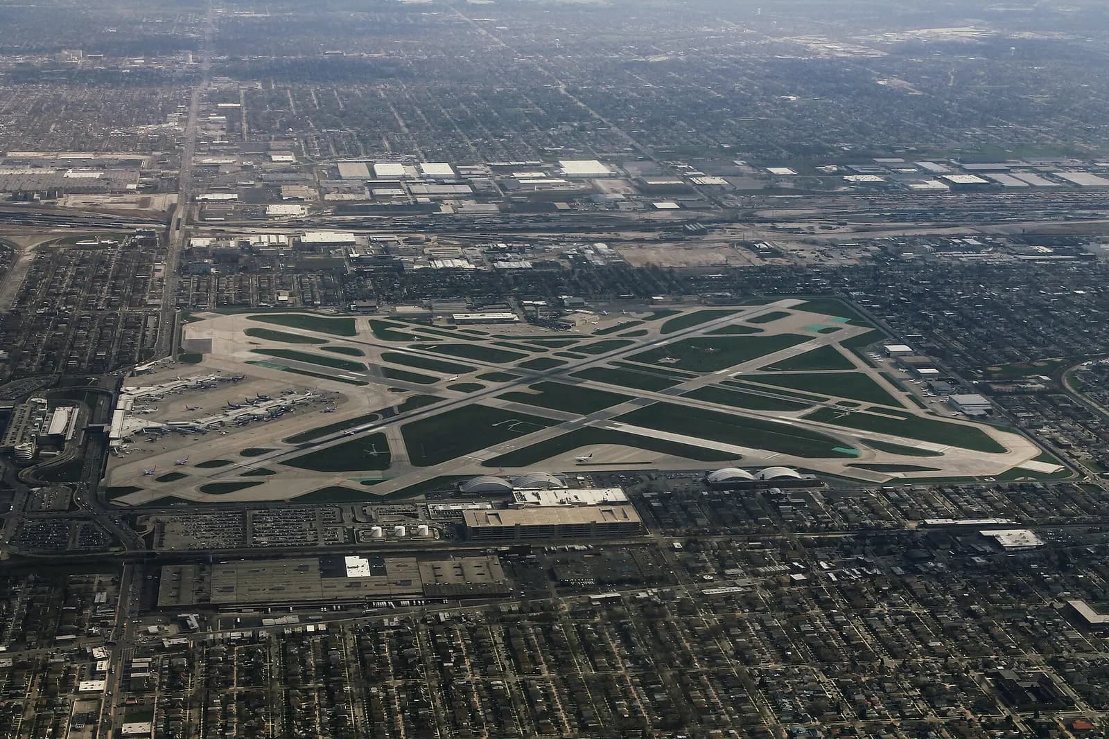 Aerial overview of Chicago Midway Airport terminals and surrounding southwest-side neighborhoods