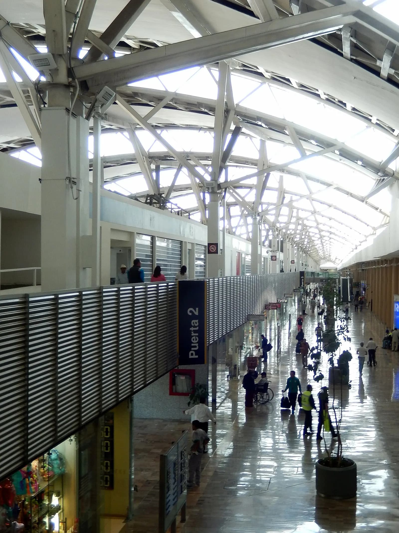 Exterior facade of Terminal 1 at Mexico City International Airport, showing the main building, entrance areas, and surrounding airport infrastructure.
