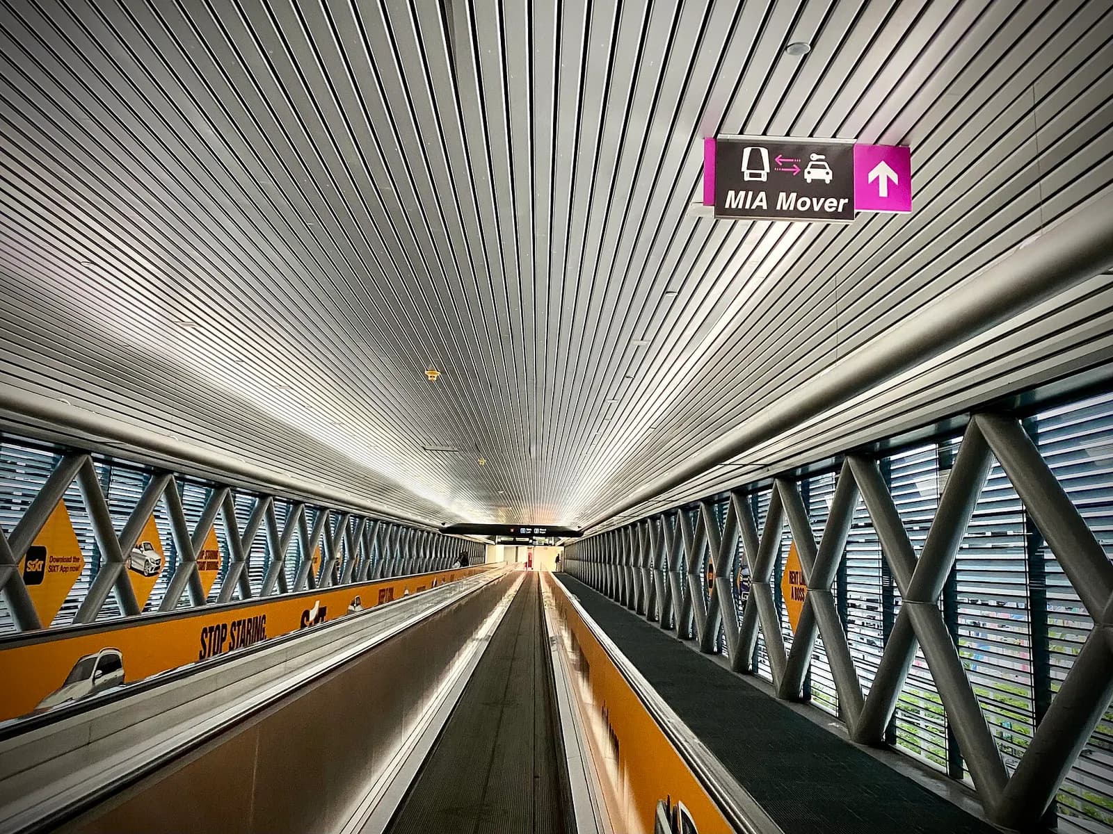 The automated MIA Mover train running on an elevated guideway between airport terminals and parking structures.