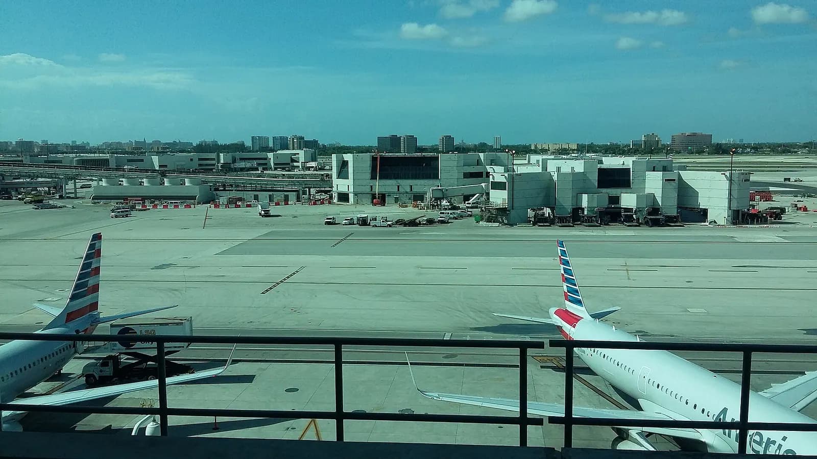 A view of Central Terminal Concourse E from a Skytrain station, showing the concourse roof and gate areas below.