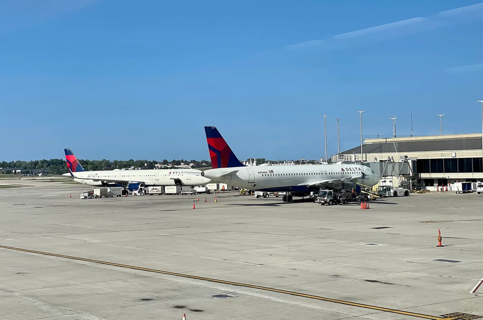 Delta Airbus on the Concourse D ramp at gate D44 with ground equipment.