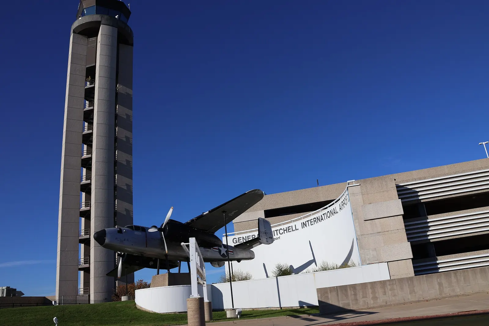 Exterior wall reading General Mitchell International Airport with the B-25 Mitchell display and control tower.