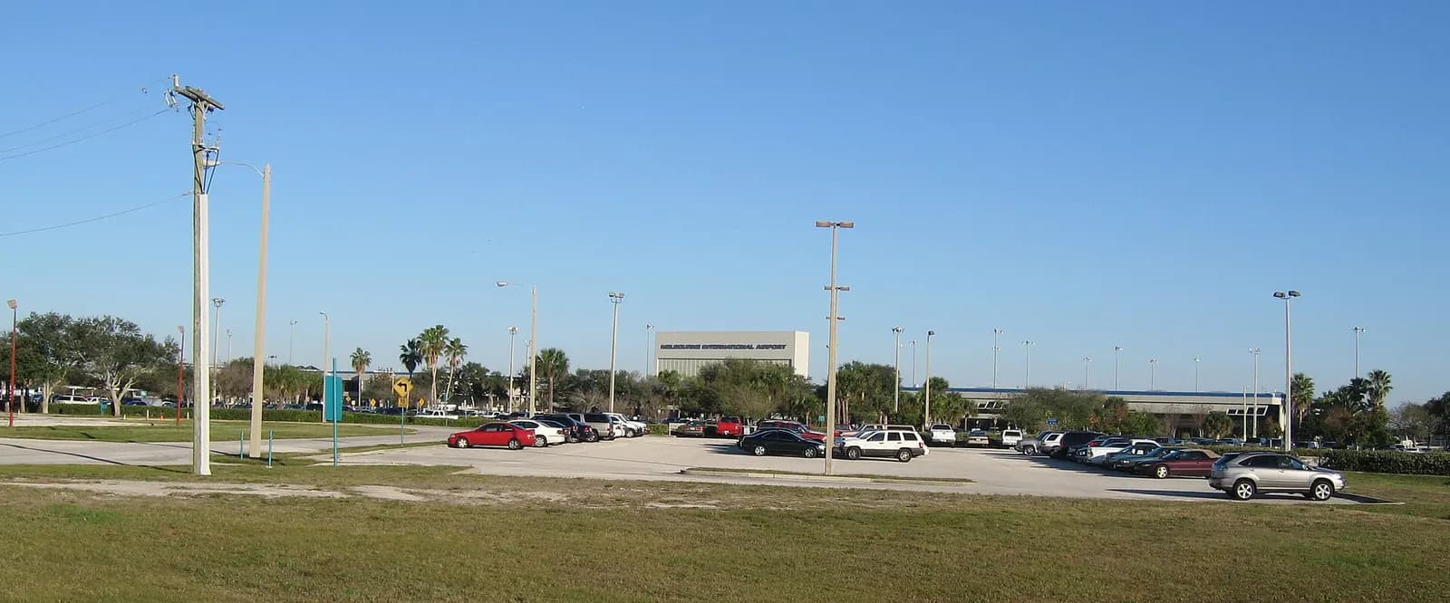Wider front elevation of the Melbourne passenger terminal with the roadway in the foreground.