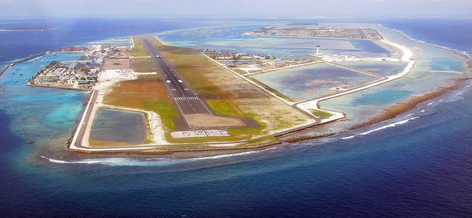 Aerial view of Velana International Airport on Hulhulé Island with single runway and turquoise lagoon