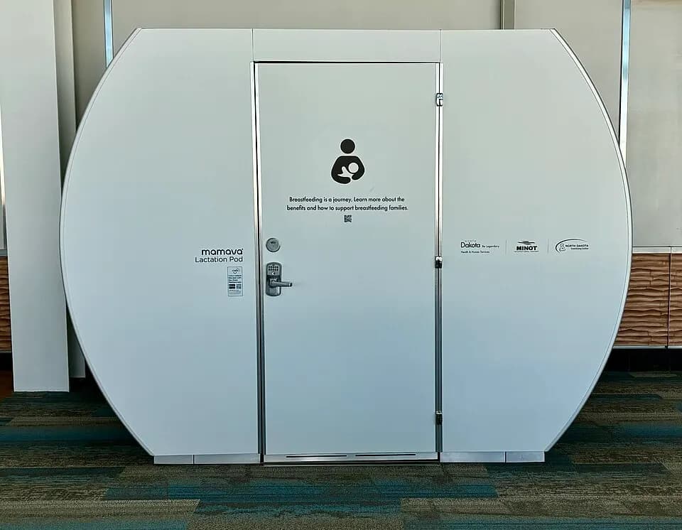 White Mamava lactation pod labeled Minot and Dakota at Minot International Airport.