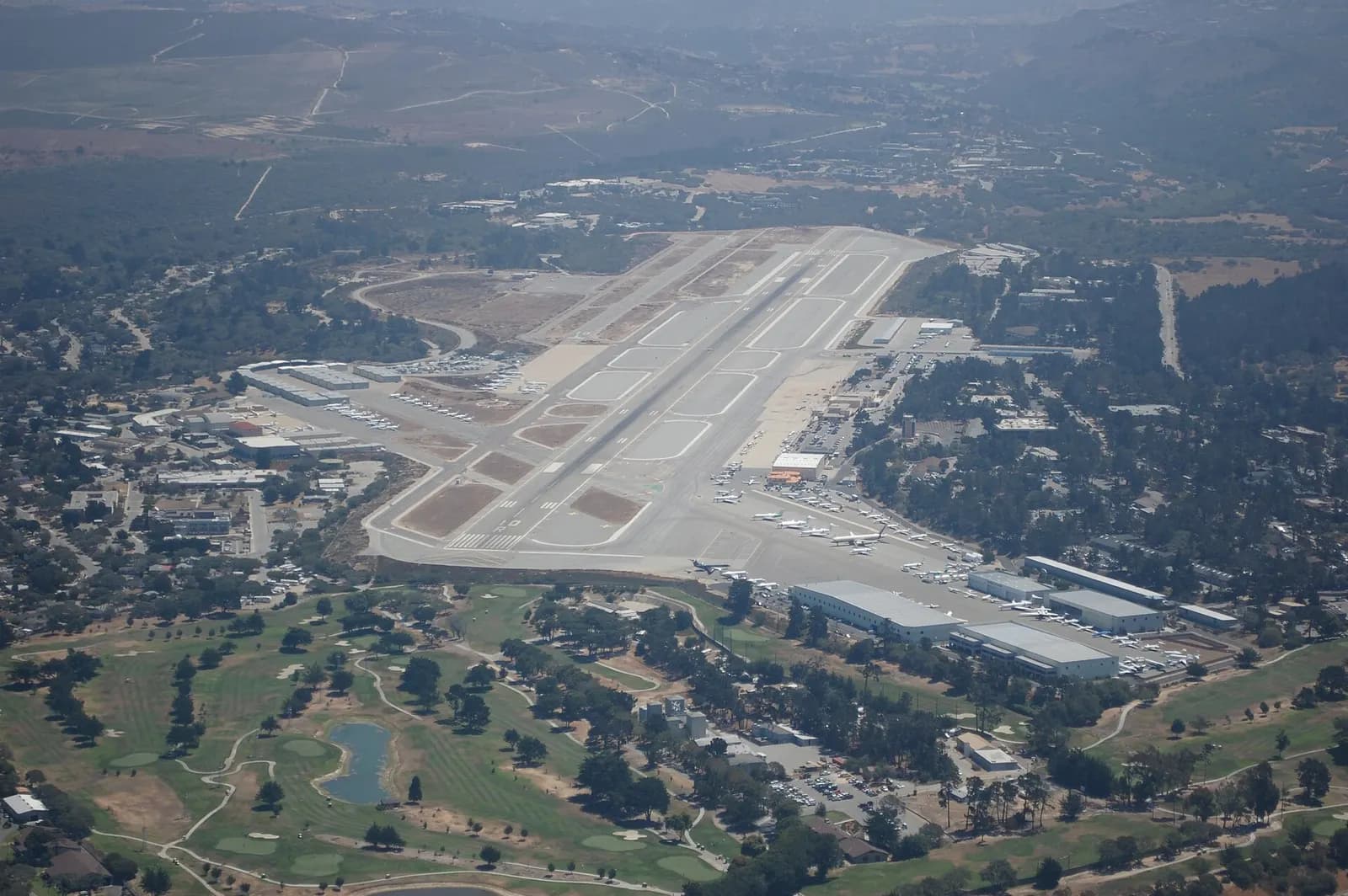 Aircraft departing Monterey Regional Airport over the terminal and airfield, photographed in 2014