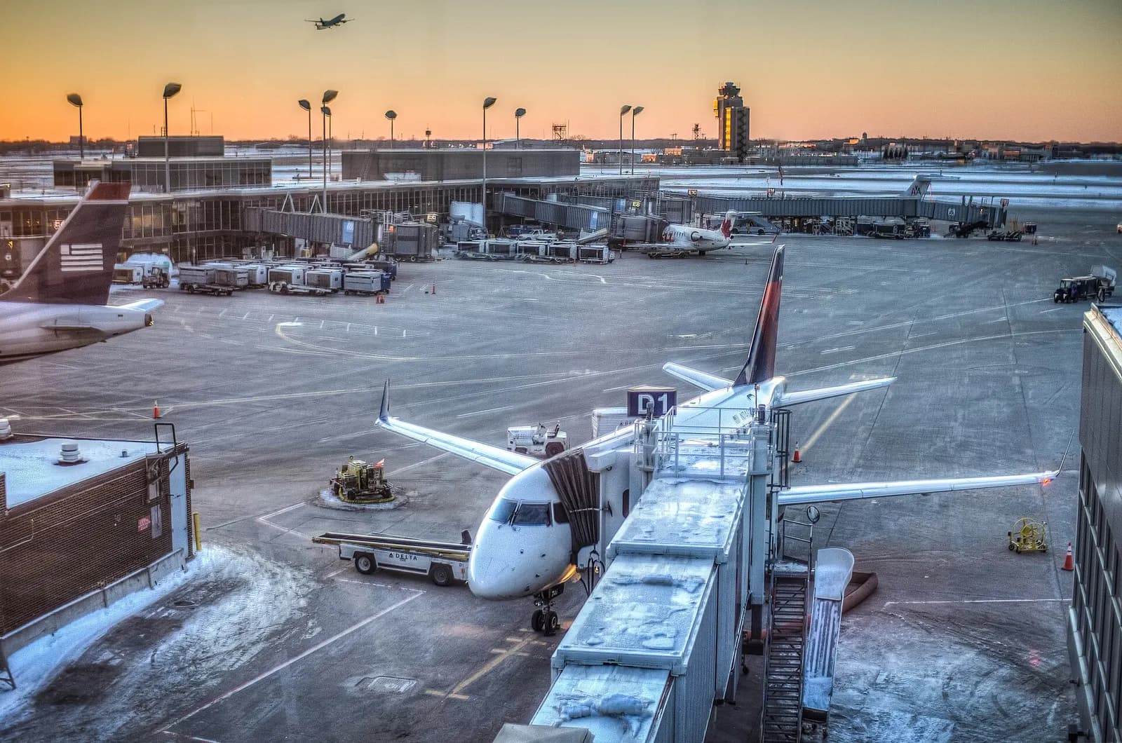 Panoramic view from MSP's airside observation deck showing parked aircraft, concourses, and runways under a dramatic sky.