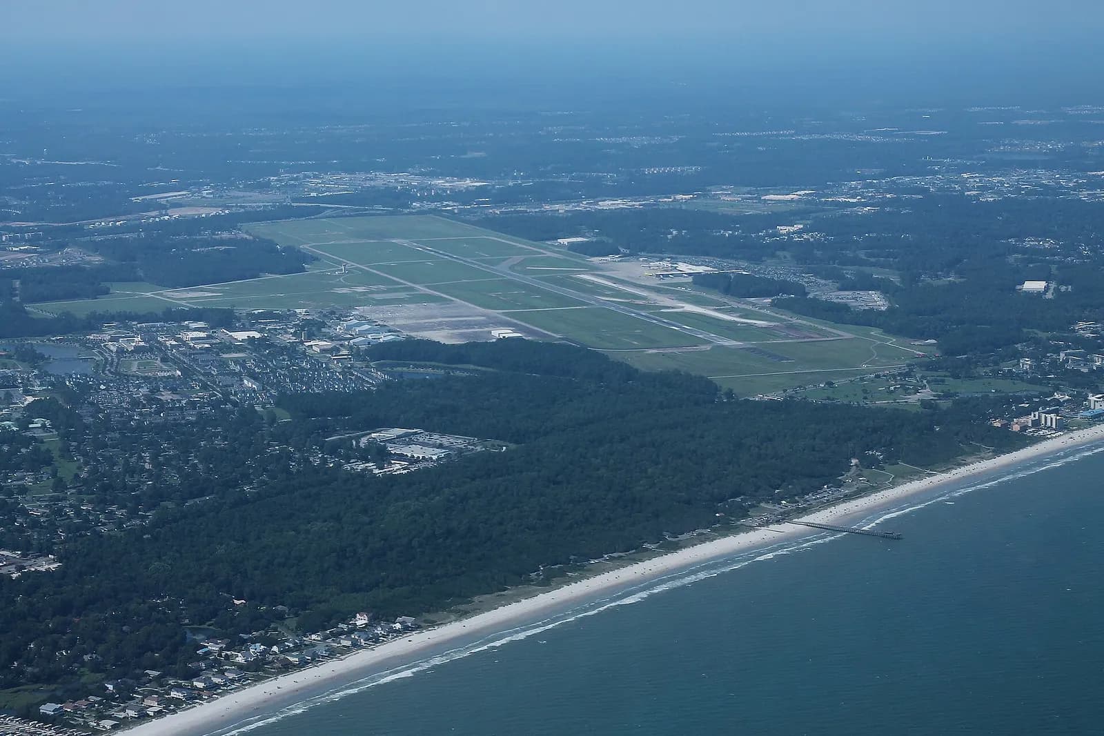 Aerial photograph of Myrtle Beach International Airport showing the single runway, terminal, and surrounding Grand Strand development.
