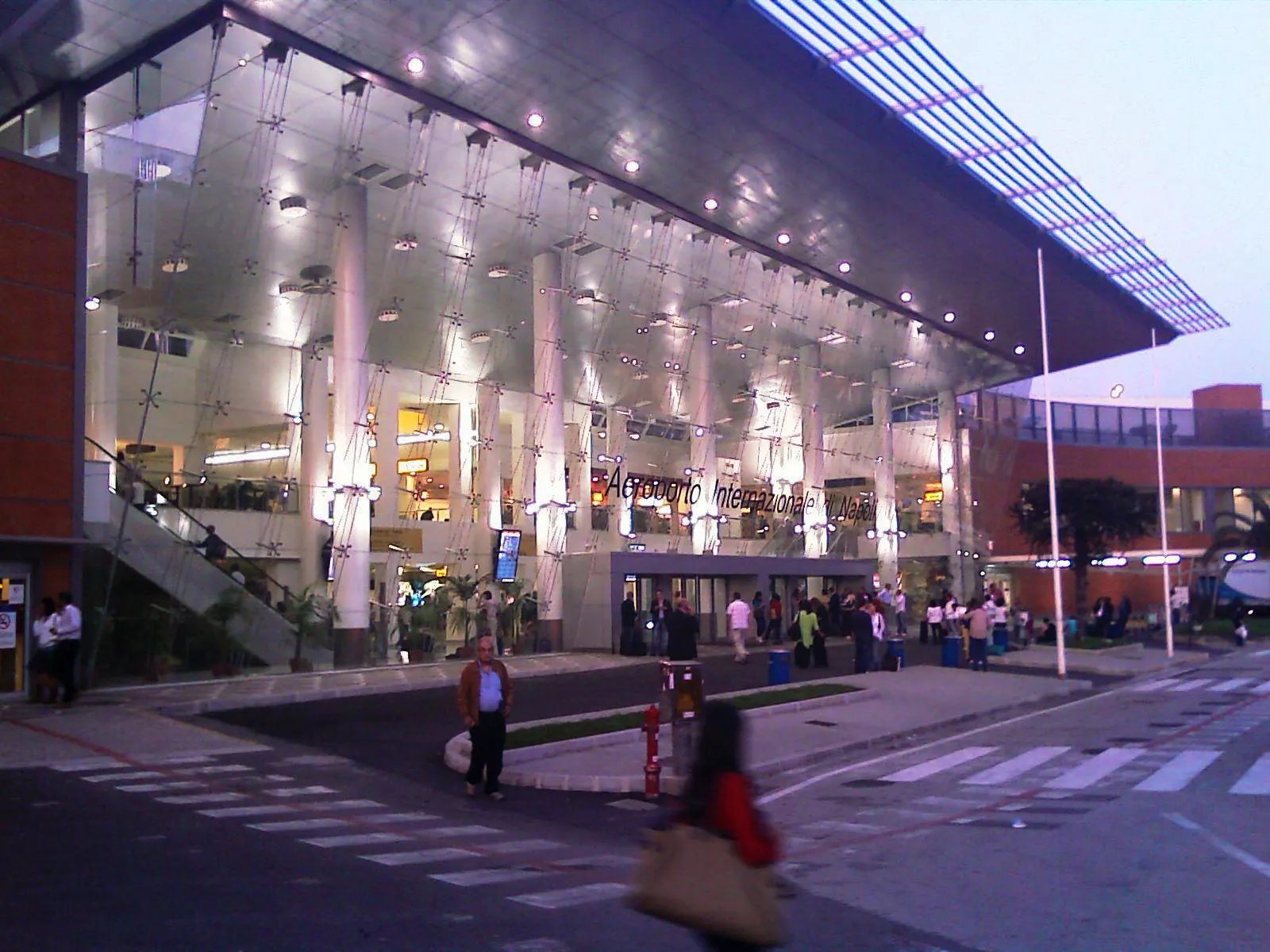 Main entrance of Aeroporto Internazionale di Napoli Capodichino at dusk