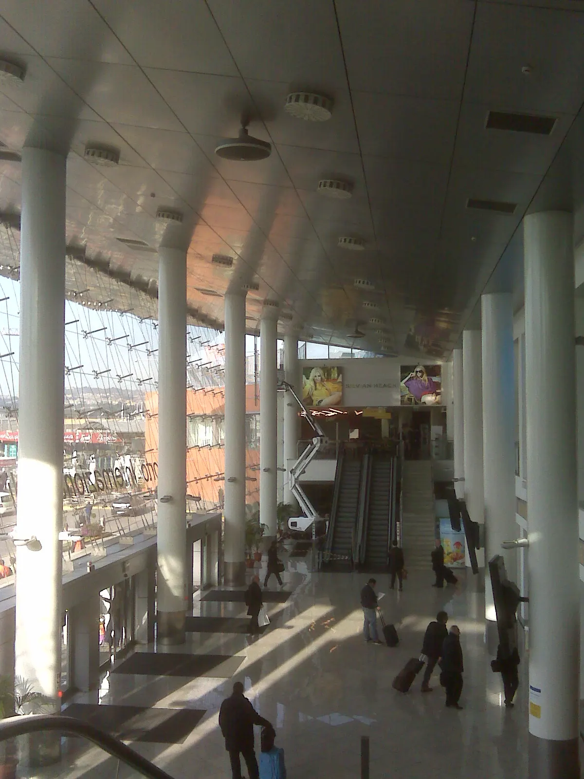 Main hall and escalators inside Naples Capodichino Airport