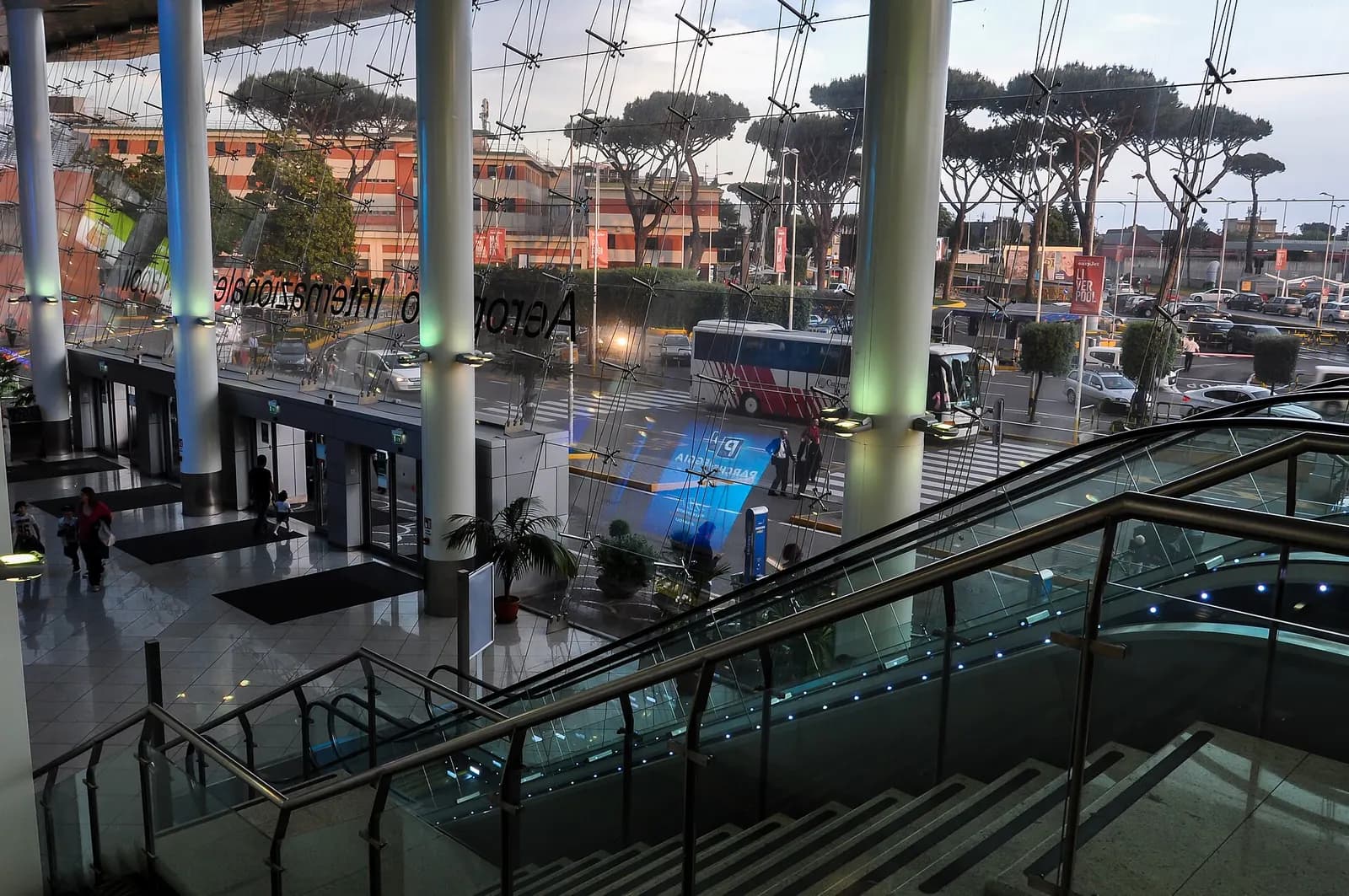 Inside Naples Capodichino terminal looking out past Aeroporto Internazionale Napoli glass signage