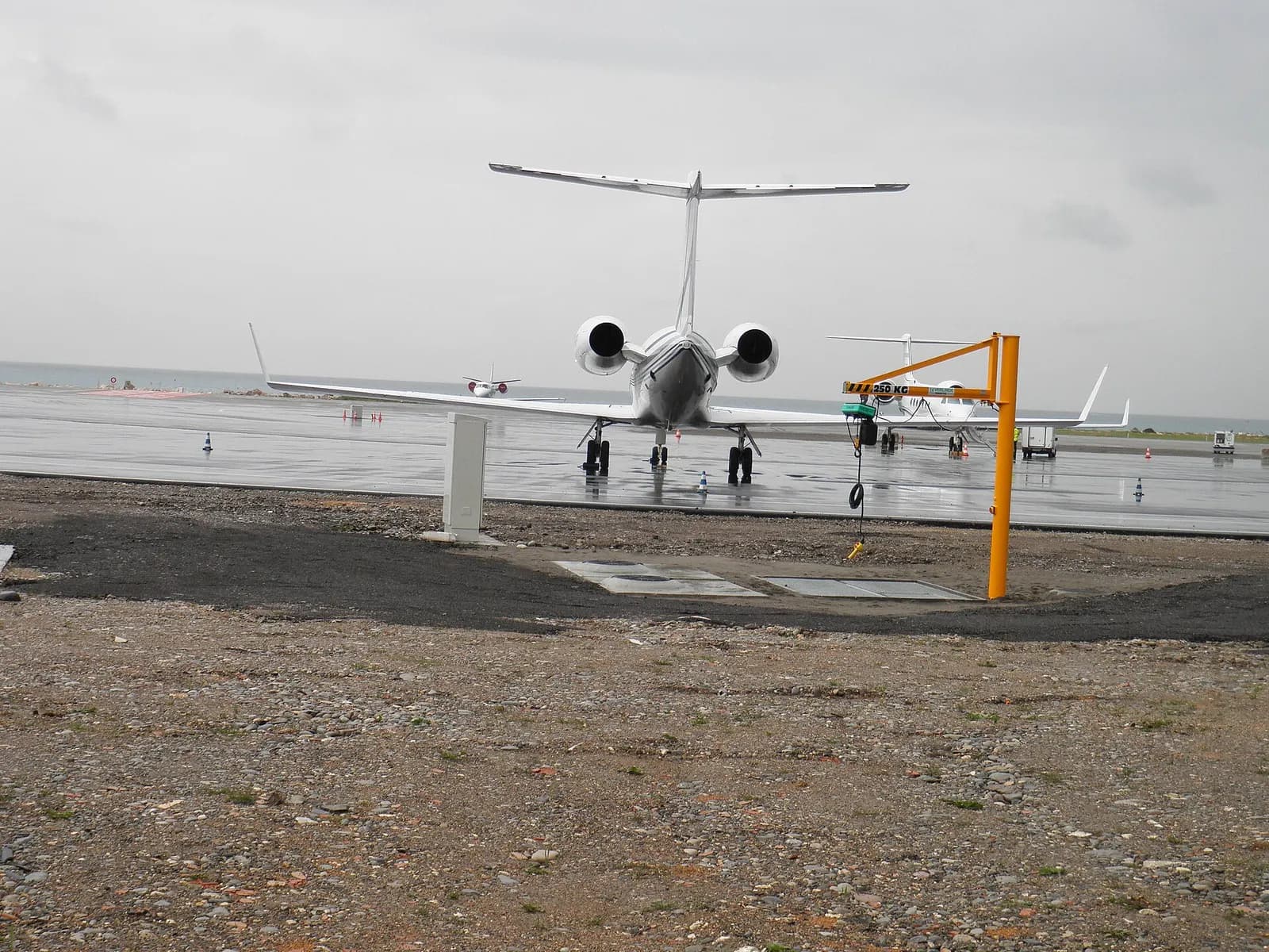 Ground-level view of the Nice Côte d'Azur International Airport terminal buildings and apron from outside the passenger area.