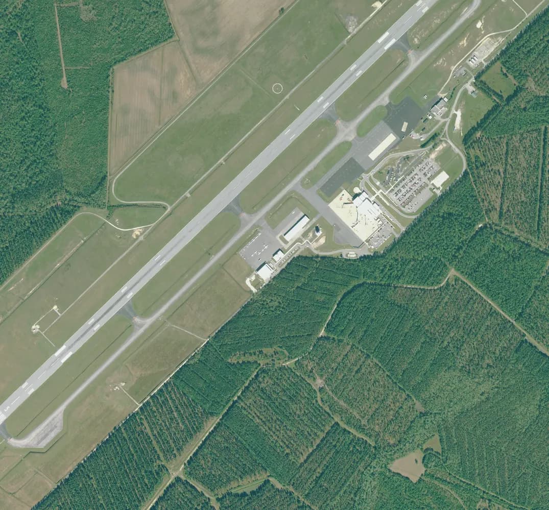2018 USDA NAIP aerial of the Albert J. Ellis passenger terminal, apron, and midfield parking next to runway 5/23.