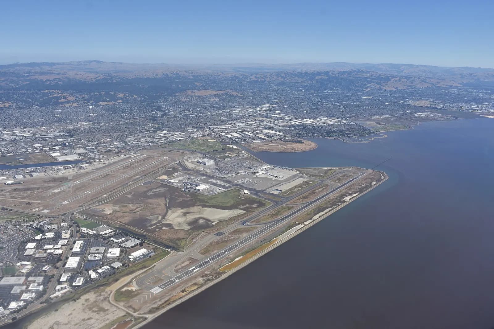 San Francisco Bay Oakland International Airport, as seen from a plane taking off from San Francisco and headed to Boston. Some blurring on the lower left is due to distortion from the aircraft window.