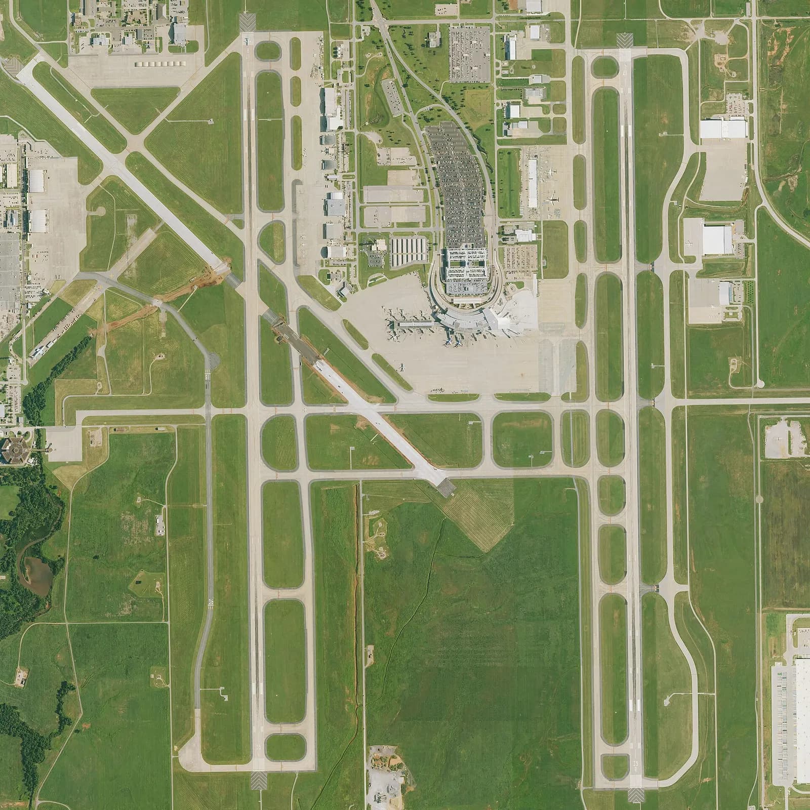 2023 USGS satellite of Will Rogers World Airport showing two parallel runways, the crosswind runway, and the passenger terminal