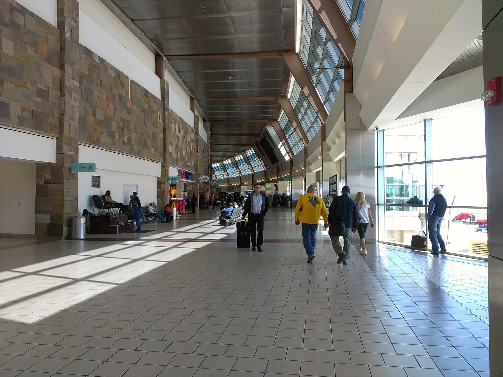 Sunlit airside concourse walkway at Will Rogers World Airport, April 2013