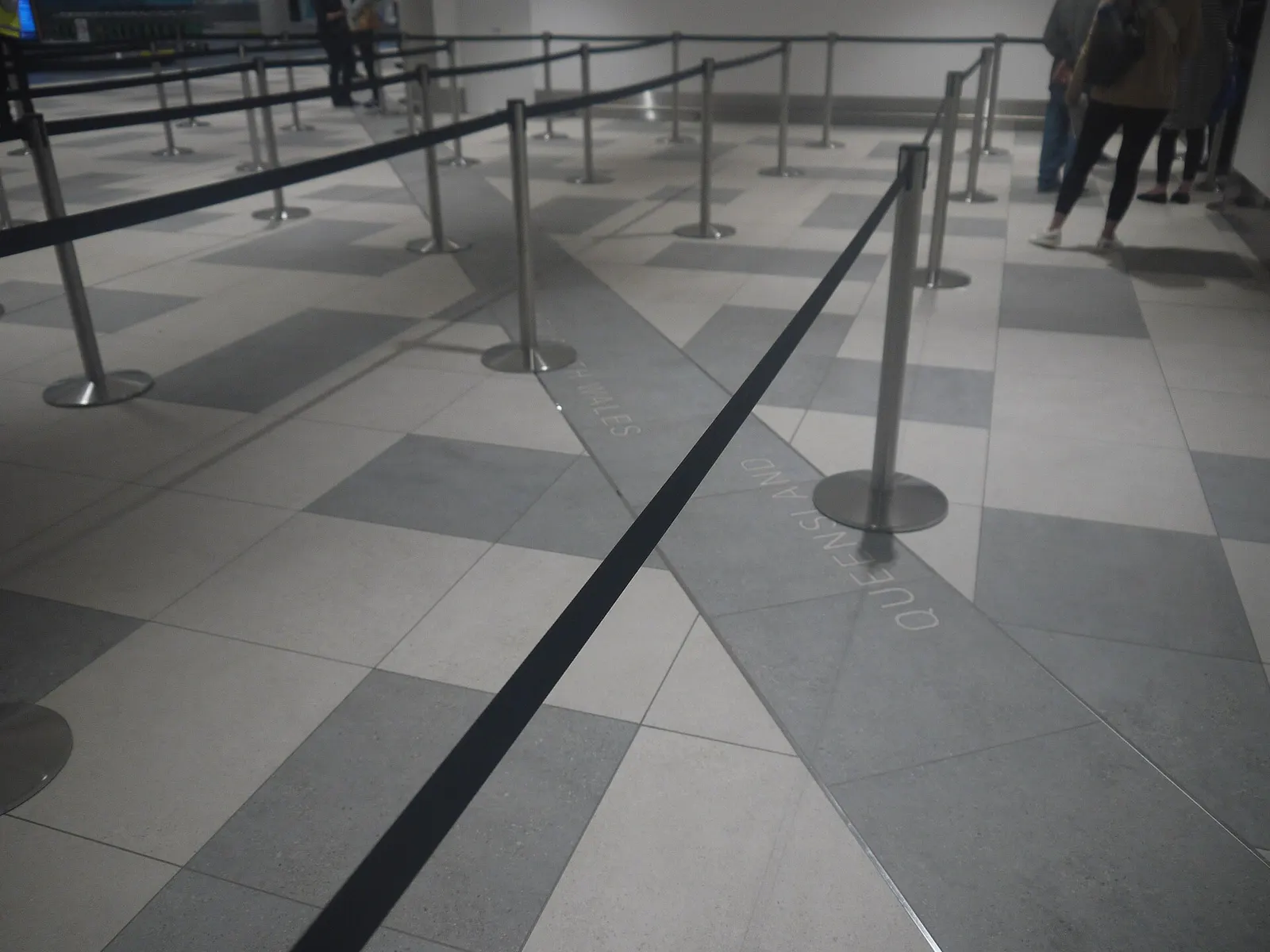 Queensland / New South Wales state border marked on Gold Coast Airport terminal floor
