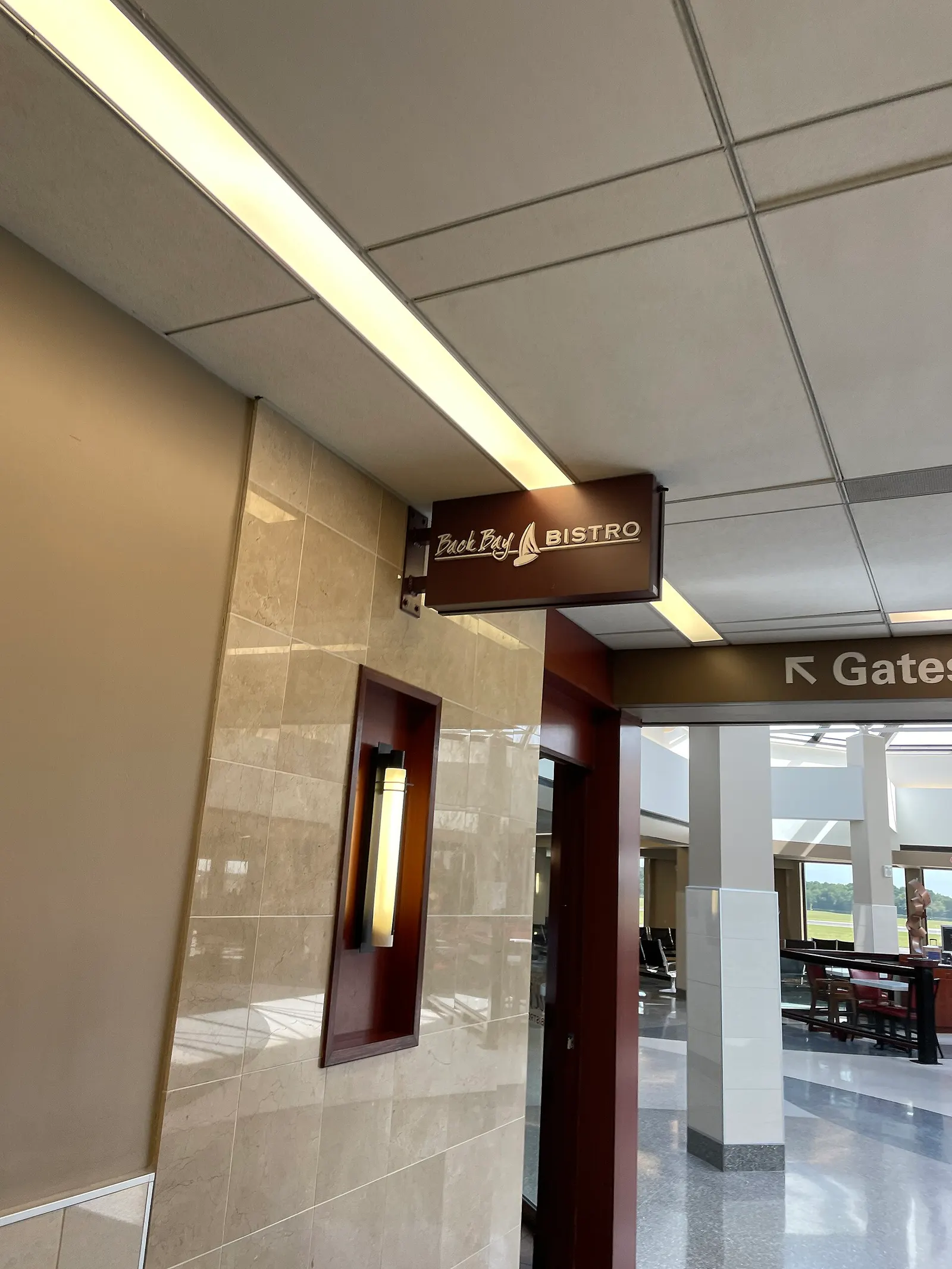 Back Bay Bistro sign on Concourse B with a Gates arrow beyond the doorway.