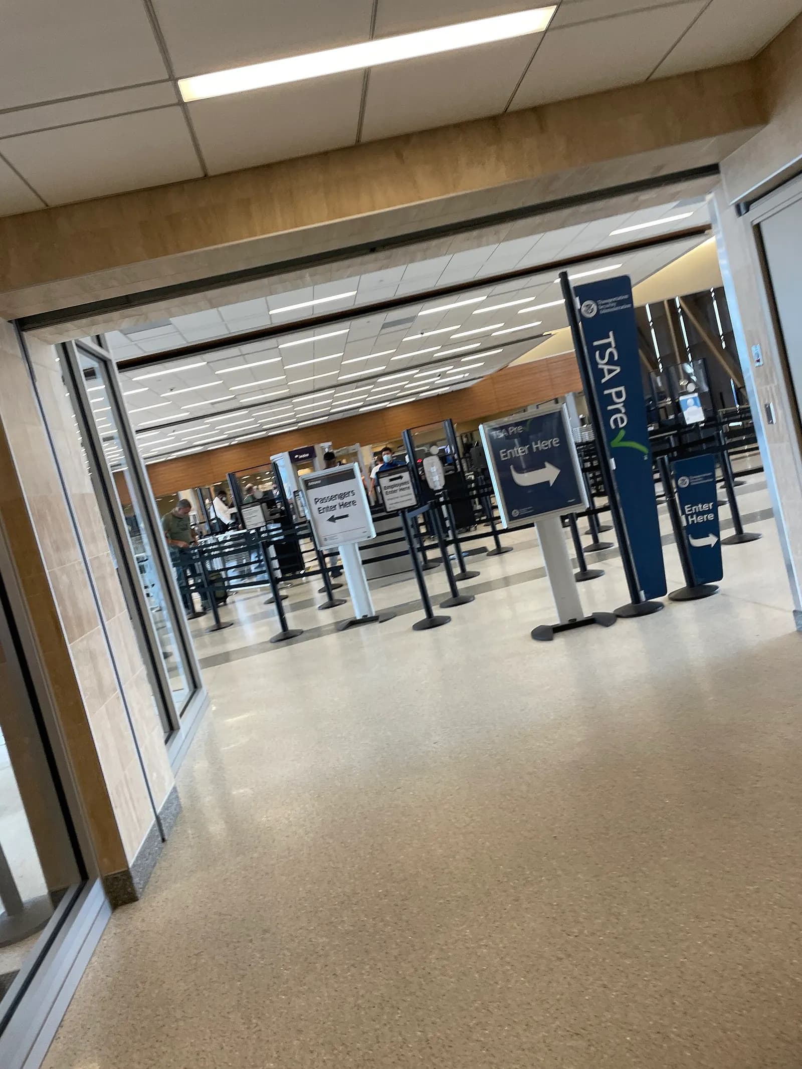 TSA PreCheck lane at a Norfolk International concourse checkpoint, with stanchions and Enter Here signs.