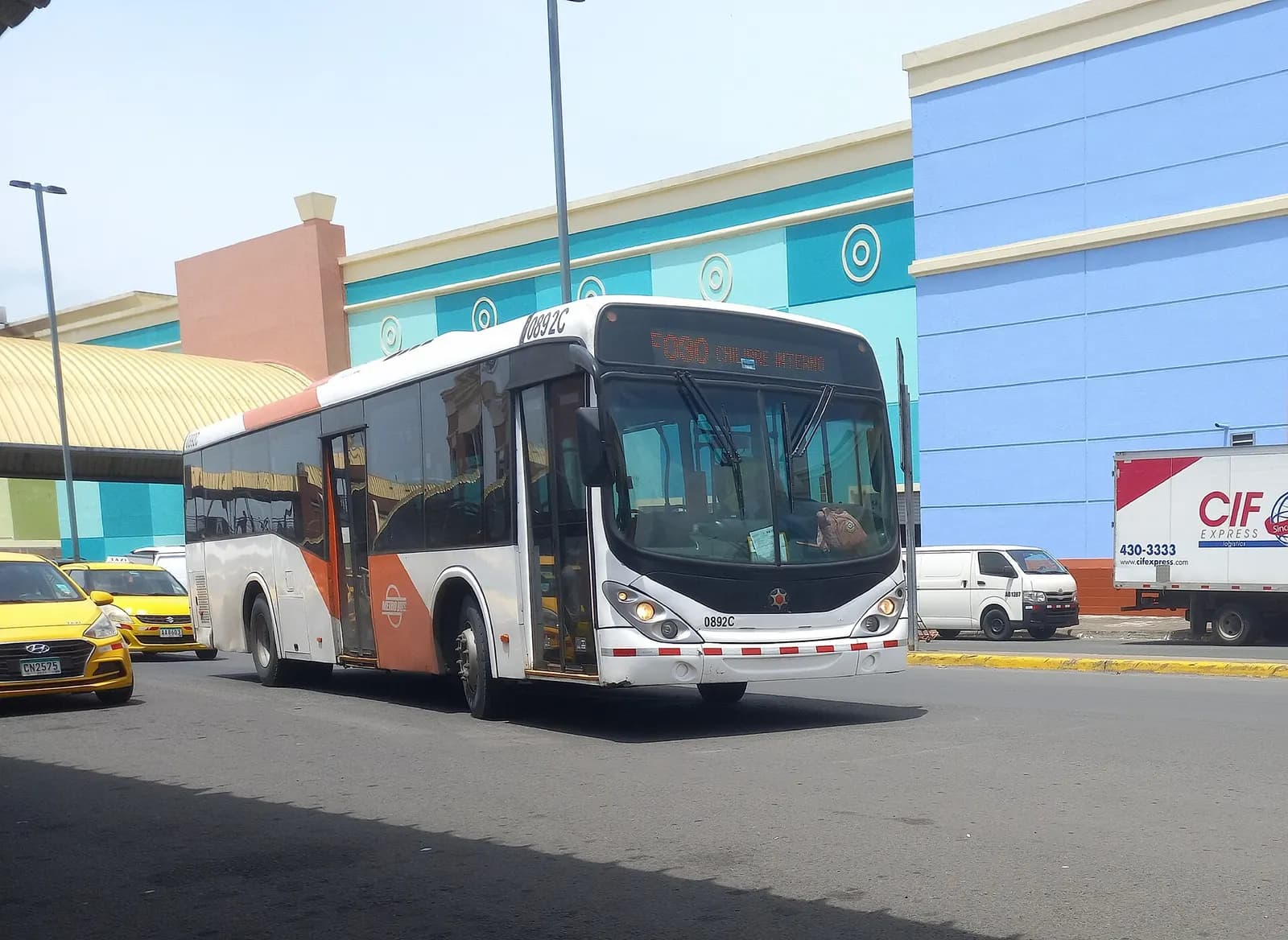 Red-and-white Metrobus pulling up at the National Transport Terminal of Panama.