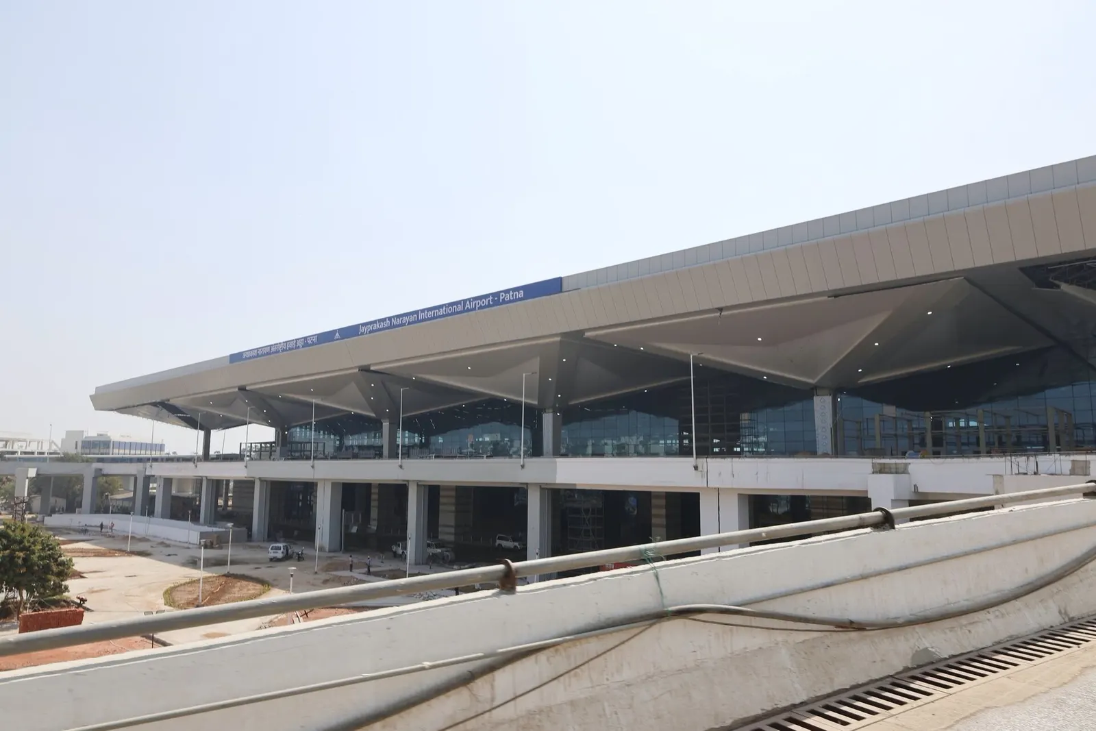 New Patna airport terminal glass façade and cantilevered roof from the approach ramp