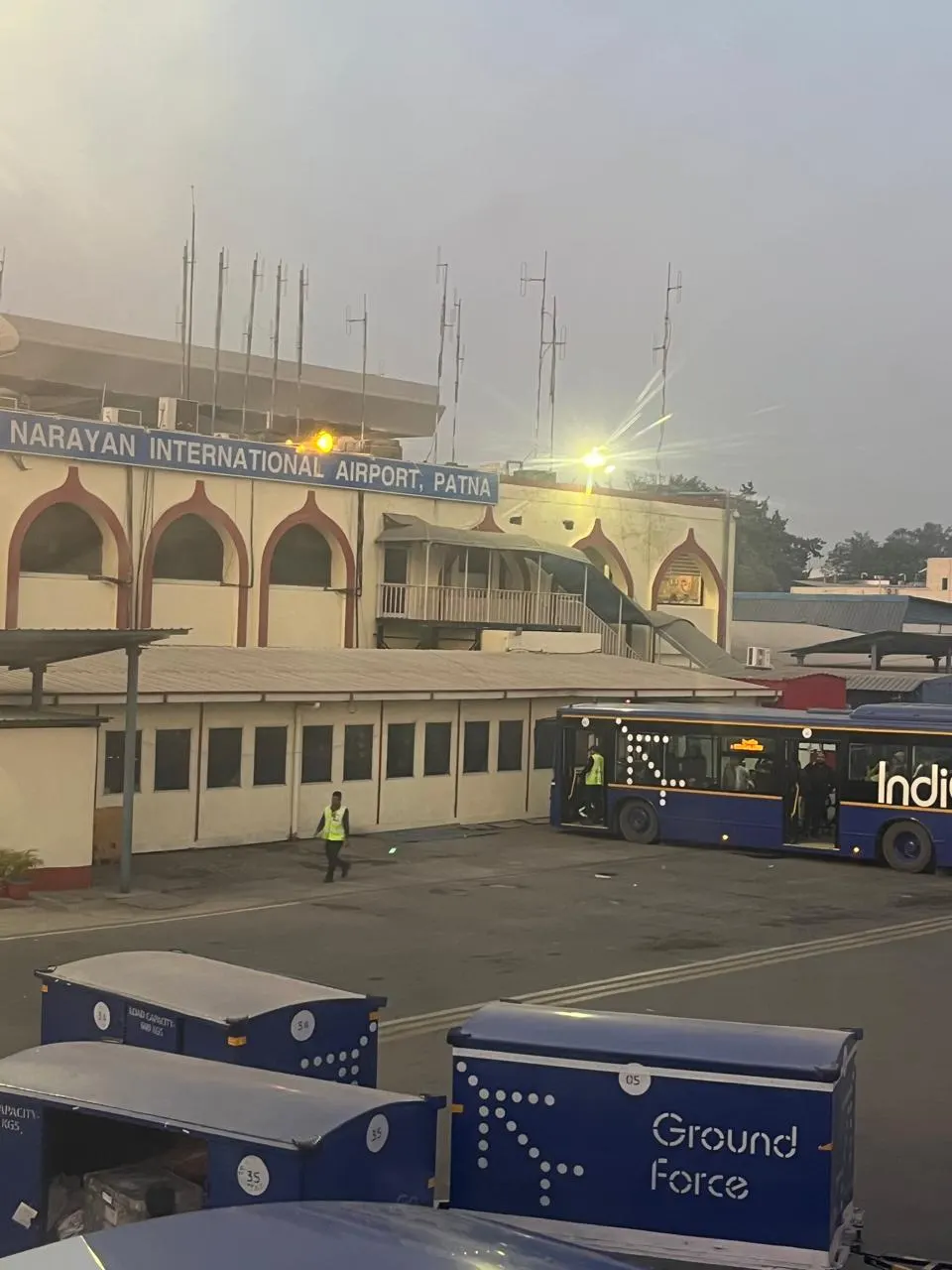 Patna airport apron with IndiGo bus and Ground Force dollies at the former terminal