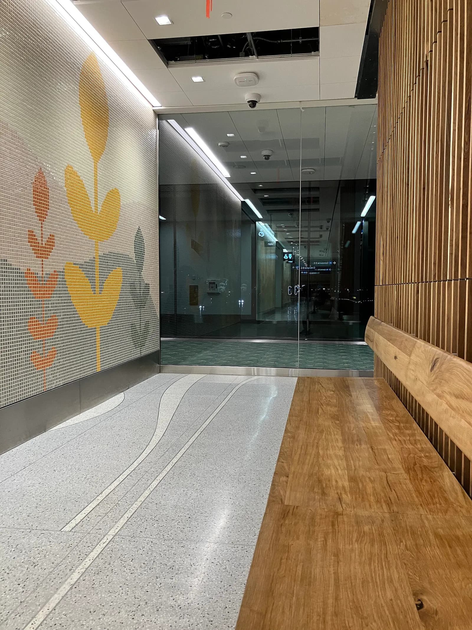 A mural near a set of restrooms in the remodeled Portland International Airport terminal