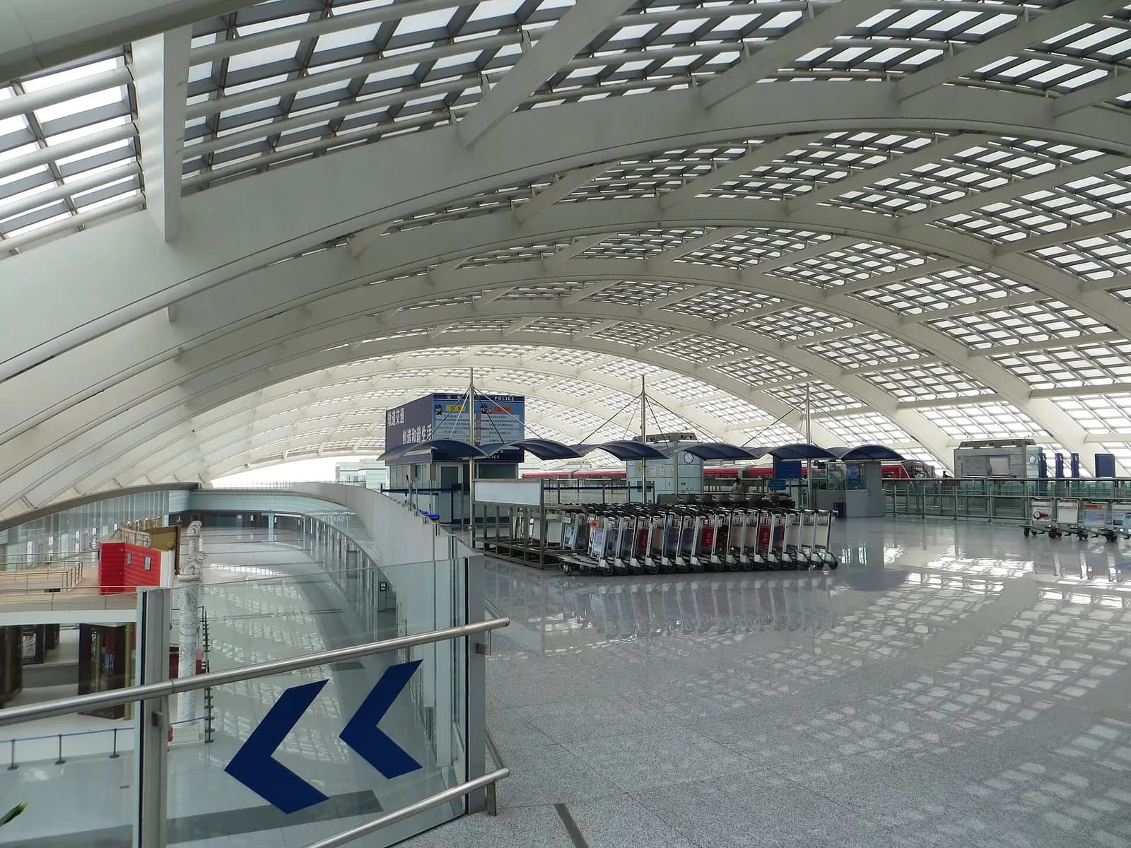 Airport Express subway train stopped at the Terminal 3 station platform with signage for the line to central Beijing.
