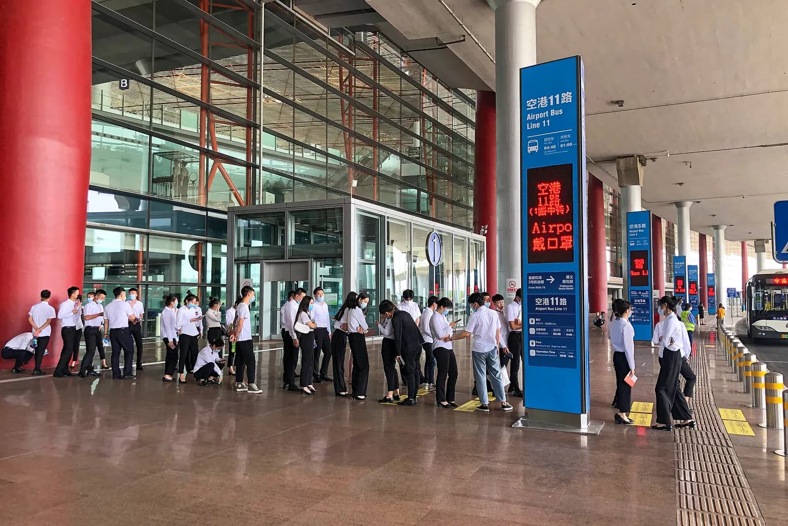 Ground Transportation Centre at Terminal 3 with shuttle buses parked at outdoor boarding bays and covered passenger walkways.