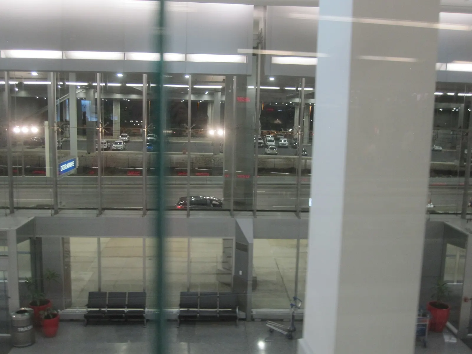 The glass-fronted entrance to Terminal A at Philadelphia International Airport, with doors, signage, and passengers approaching the building.