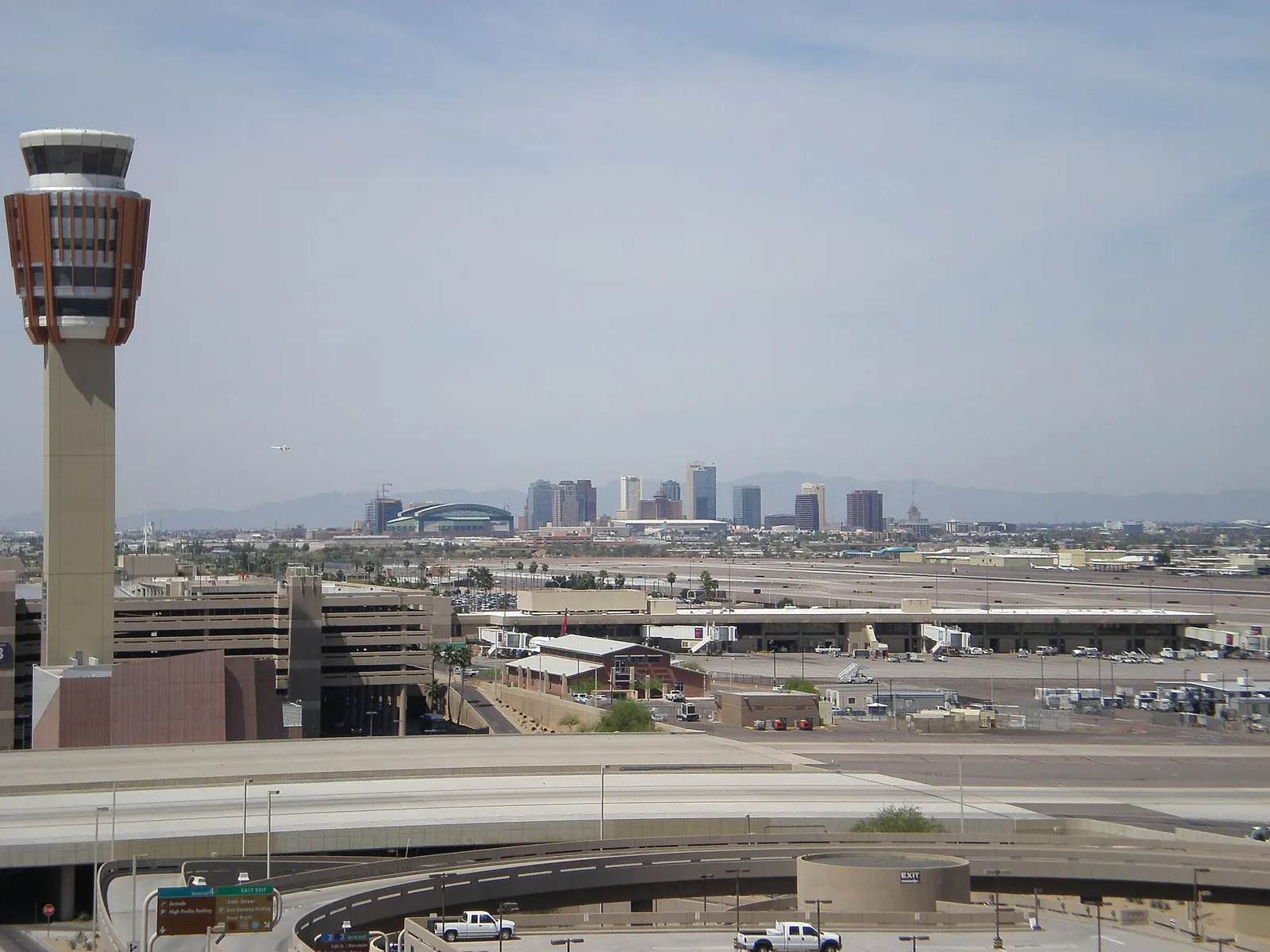 The Phoenix Sky Harbor air traffic control tower in the foreground with the downtown Phoenix skyline rising behind it.