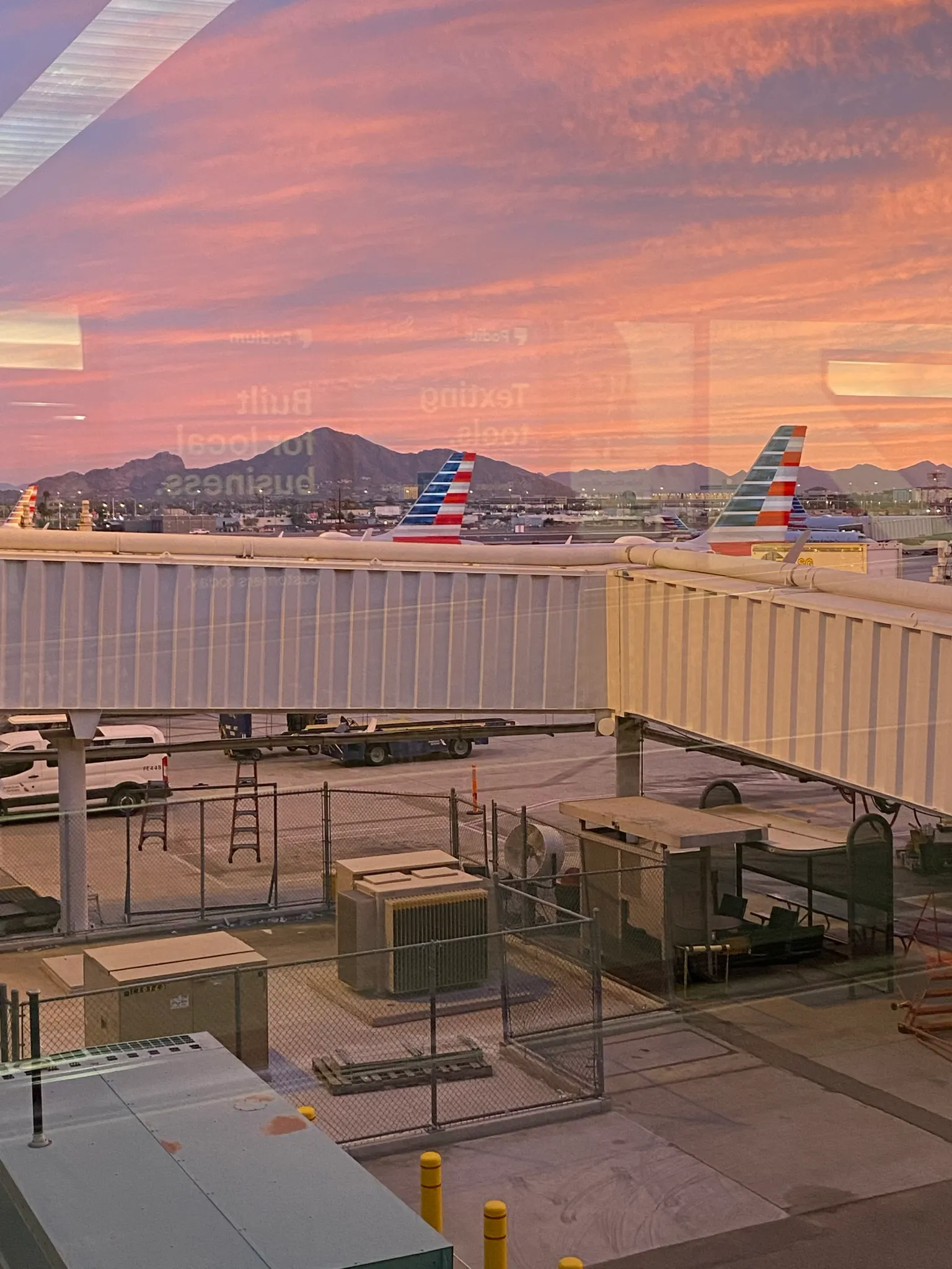 An interior view of the Phoenix Sky Harbor terminal concourse with high ceilings, walkways, and passenger areas.